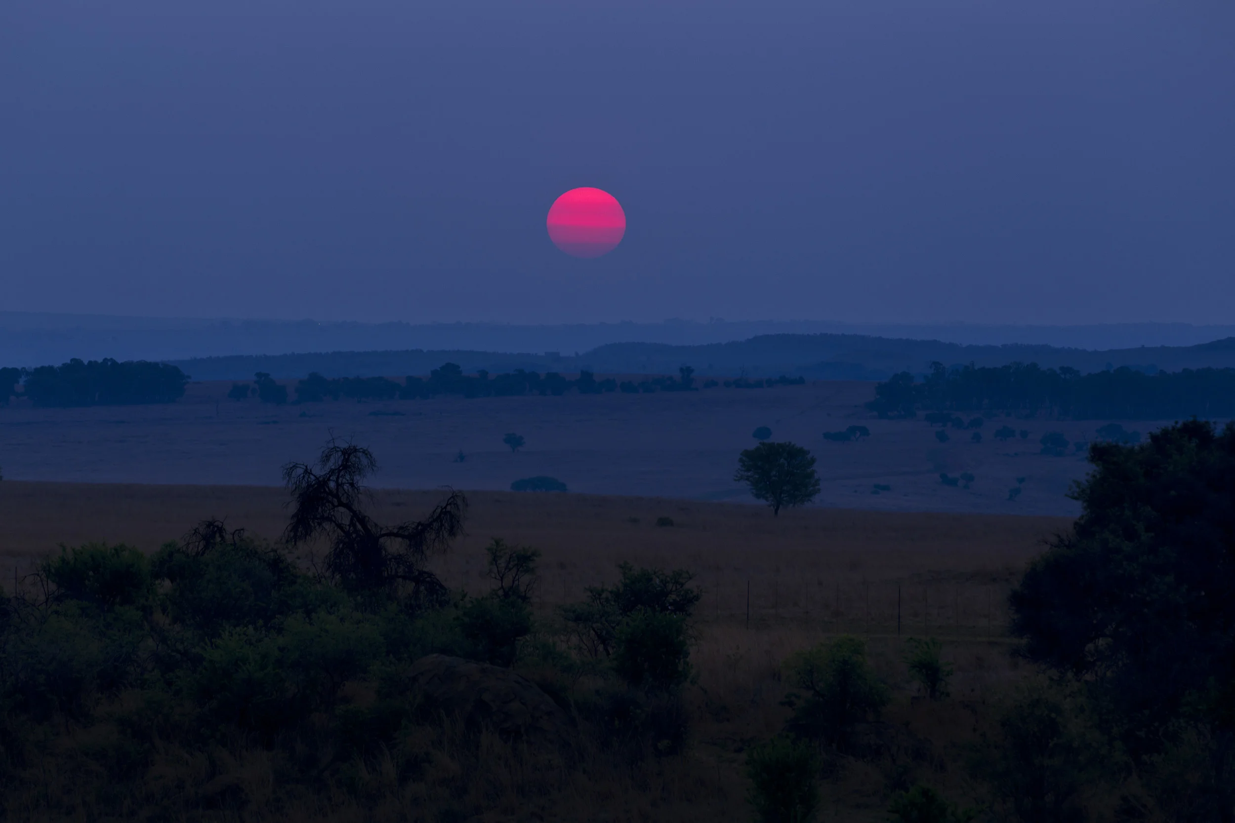 THE CRADLE OF HUMANKIND, GAUTENG, SOUTH AFRICA, OCTOBER 2010: Sunset over the Cradle of Humankind as seen from the Maropeng visitor's center at the Cradle of Humankind World Heritage Site, Gauteng, South Africa, 8 October 2010. Maropeng means “returning to the place of origin” in Setswana, the main indigenous language in this area of South Africa. This is a center devoted to human origins and the children undertake a journey into the origins of man as they tour the facility. The recent Sediba discovery has re-energised the Paleolithic world in the minds of people in South Africa and there is more interest in early man and the fossil rich Cradle of Humankind than ever before. (Photo by Brent Stirton/Reportage for National Geographic.)