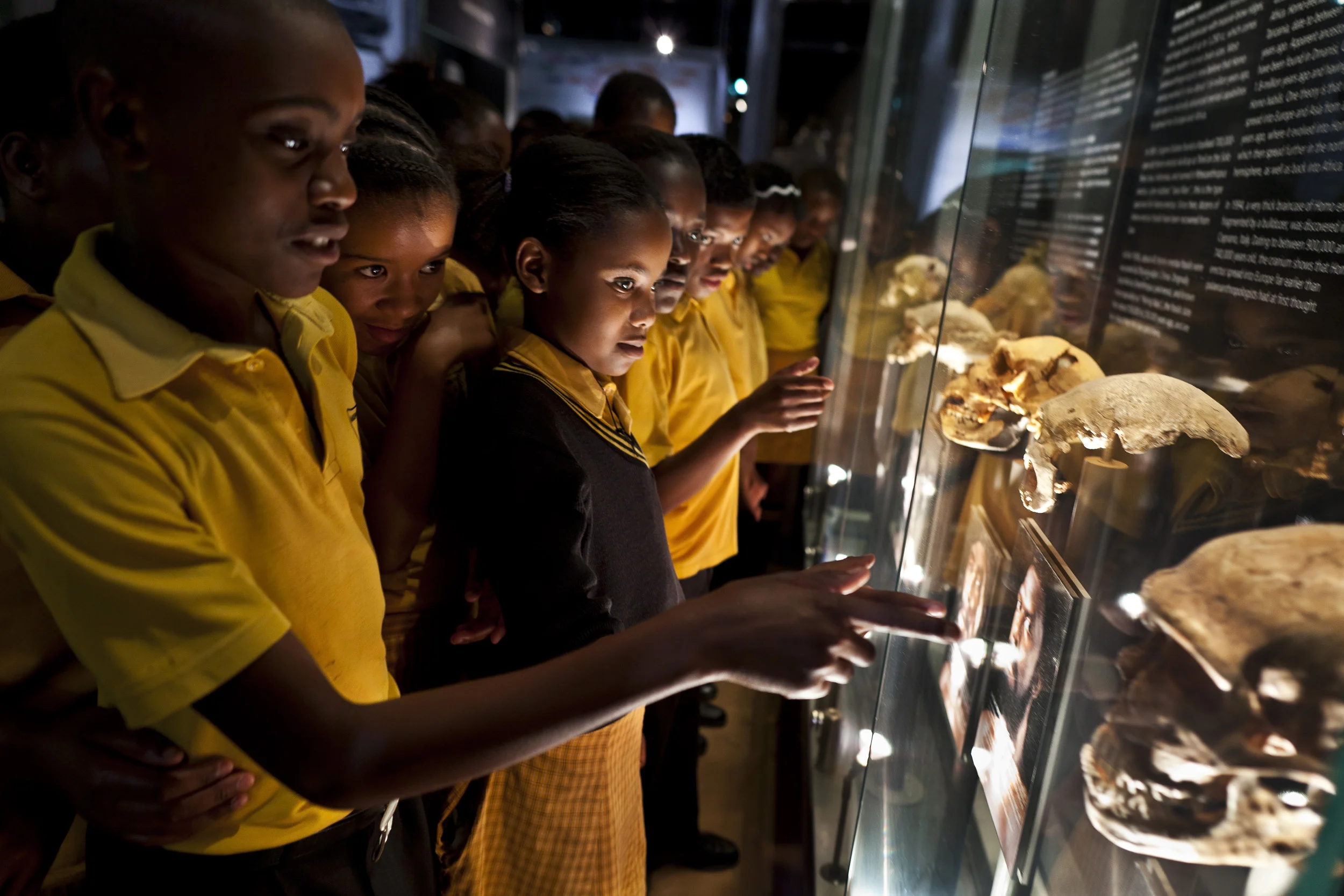 THE CRADLE OF HUMANKIND, GAUTENG, SOUTH AFRICA, OCTOBER 2010: Schoolchildren from the Marapo A-Thutlwa Primary school visit Maropeng visitor's center at the Cradle of Humankind World Heritage Site, Gauteng, South Africa, 8 October 2010. Maropeng means “returning to the place of origin” in Setswana, the main indigenous language in this area of South Africa. This is a center devoted to human origins and the children undertake a journey into the origins of man as they tour the facility. The recent Sediba discovery has re-energised the Paleolithic world in the minds of people in South Africa and there is more interest in early man and the fossil rick Cradle of Humankind than ever before. (Photo by Brent Stirton/Reportage for National Geographic.)