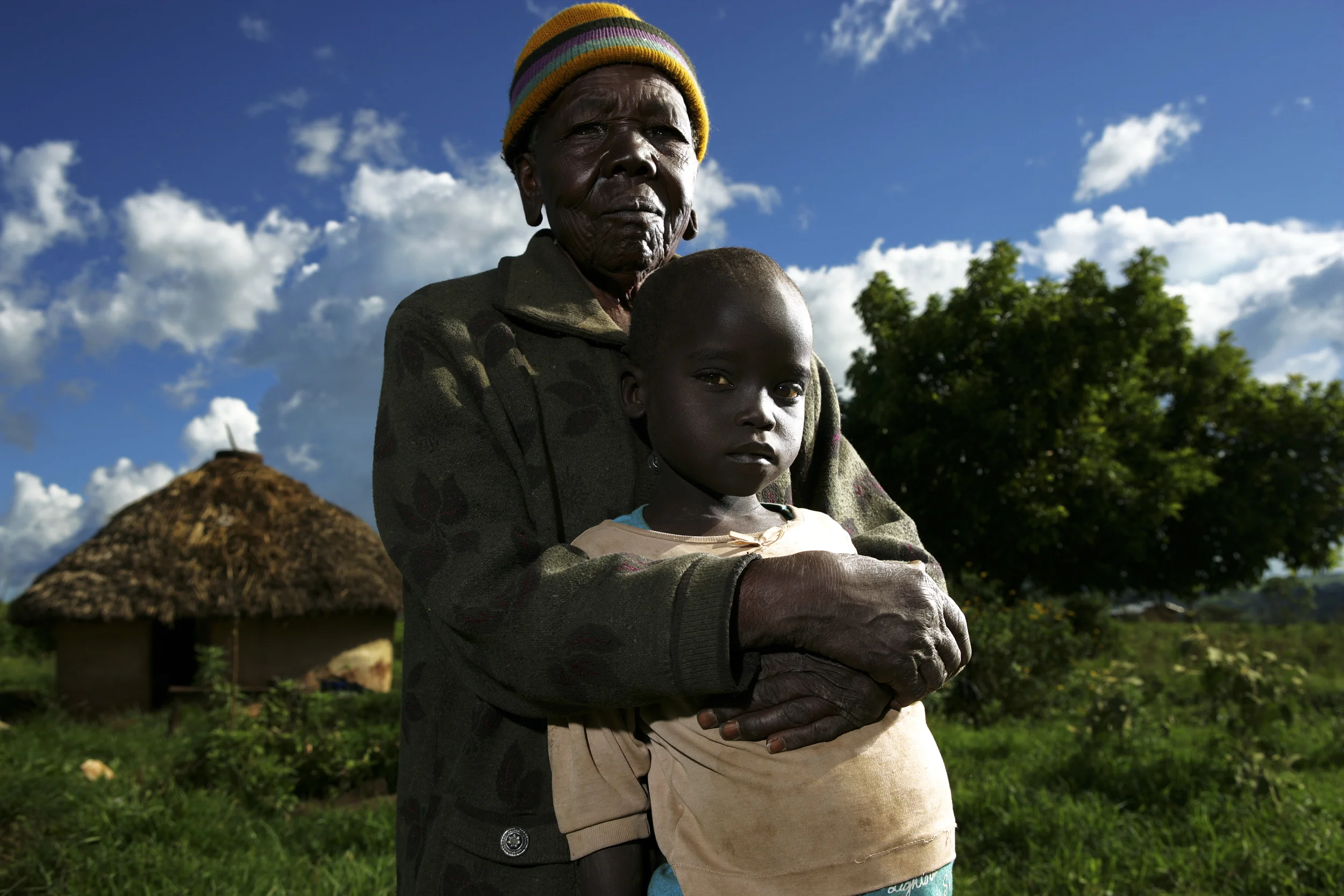 Rural Kenya - December 2006: An Aids affected grandmother with their grandchildren who they have had to adopt as a result of the Aids death of their own children. This generation gap makes for far less opportunity for these children and places tremendous pressure on the elderly. HIV rates in Kenya are now at 5 to 1 in terms of women to men, indicating a strong feminisation of the disease. Women are banding together in an effort to educate each other about the disease and to provide care and support for those living with HIV/Aids. Photo by Brent Stirton/Getty Images for the Global Business Coalition against Aids.
