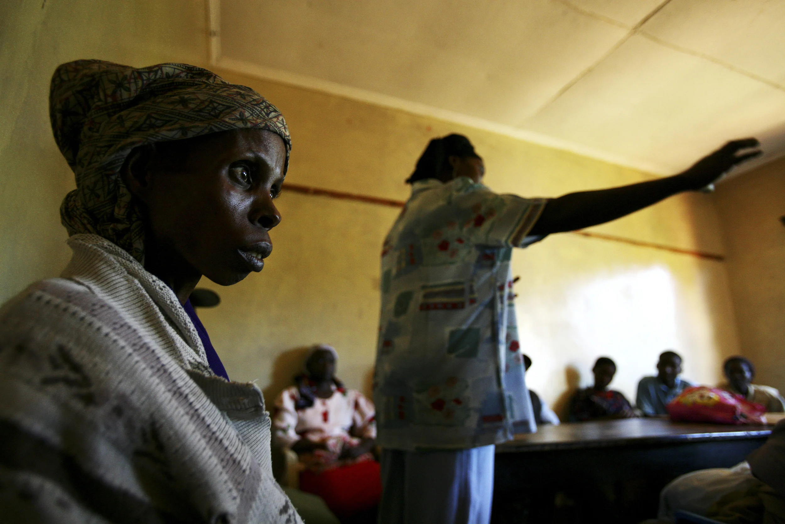 Meru, Kenya-28 November 2006: Elisabeth Mweru,28, feeding herself again for the first time in weeks as she recovers from severe tuberculosis. Elizabeth was found in an advanced stage of full blown Aids by a group of self-supporting HIV+ women in her village. She has been cared for by them to the point where she can now sit up and begin to feed herself. HIV rates in Kenya are now at 5 to 1 in terms of women to men, indicating a strong feminisation of the disease. As a result groups of Kenyan HIV+ women are banding together to offer each other education and support. photo by Brent Stirton/Getty Images for the Global Business Coalition against Aids.