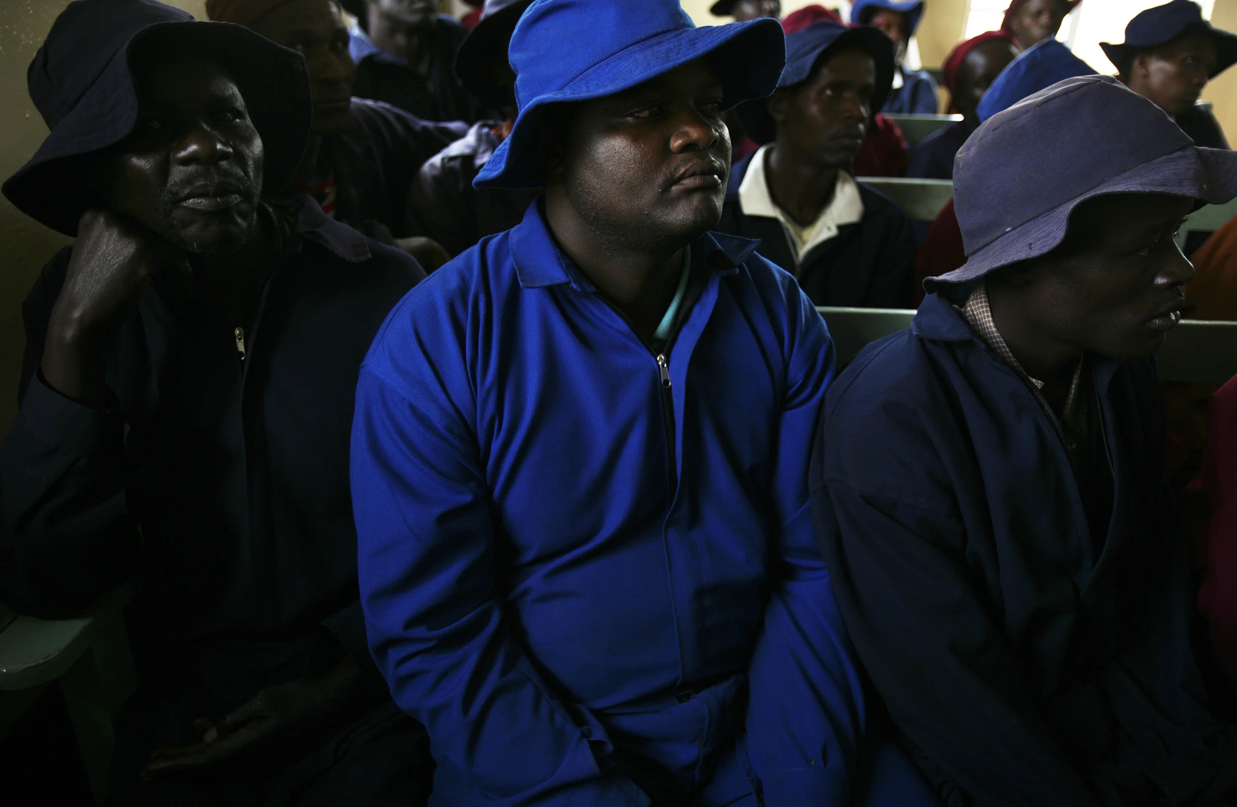 Northern Kenya, December 2006: A group of male factory workers attend an Aids sensitisation class at a timber factory in rural Kenya. Men are more respectful of women as a result and women are more aware of their rights. HIV rates in Kenya are now at 5 to 1 in terms of women to men, indicating a strong feminisation of the disease. As a result groups of Kenyan HIV+ women are banding together to offer each other education and support. photo by Brent Stirton/Getty Images for the Global Business Coalition against Aids.