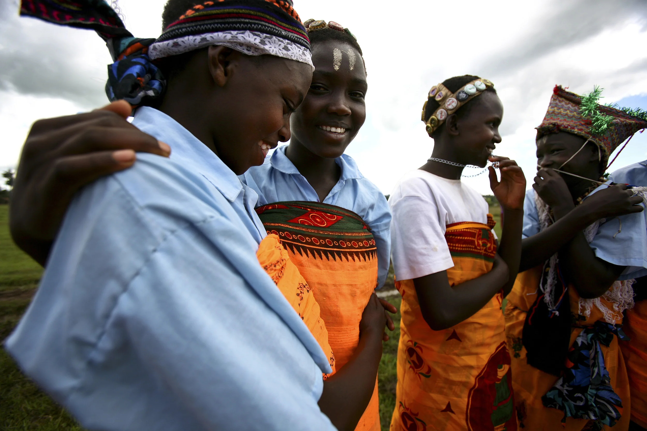 Kisumu, Kenya-5 December 2006: Young girls from a dance group using dance to discuss Aids gather after a church meeting in rural Kenya. HIV rates in Kenya are now at 5 to 1 in terms of women to men, indicating a strong feminisation of the disease. Women are banding together in an effort to educate each other about the disease and to provide care and support for those living with HIV/Aids. Photo by Brent Stirton/Getty Images for the Global Business Coalition against Aids.