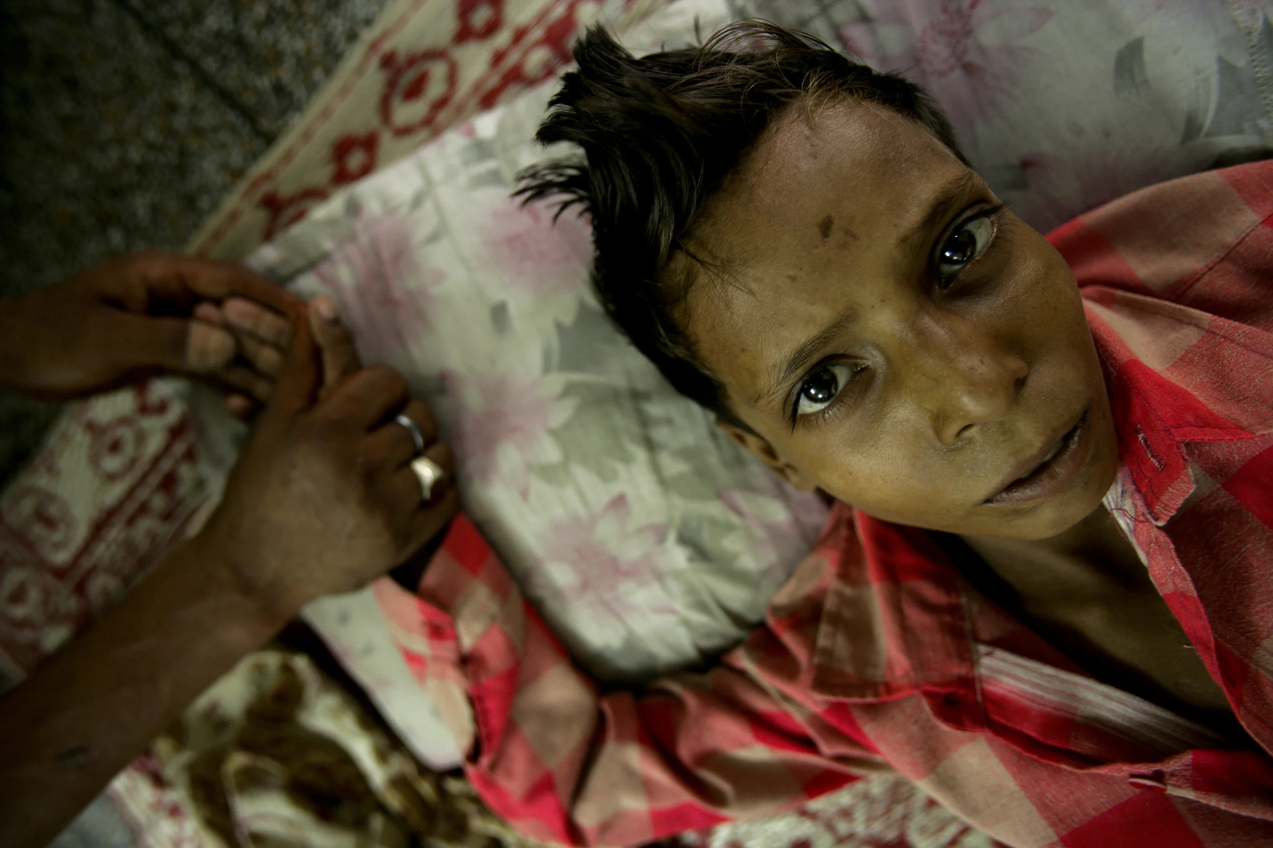 Delhi, India June 2006: Local NGO Sahara offers a shelter for Streetchildren in their Delhi clinic. This image depicts a nine year old boy, still in the midst of a drug binge, who was brought to the clinic.