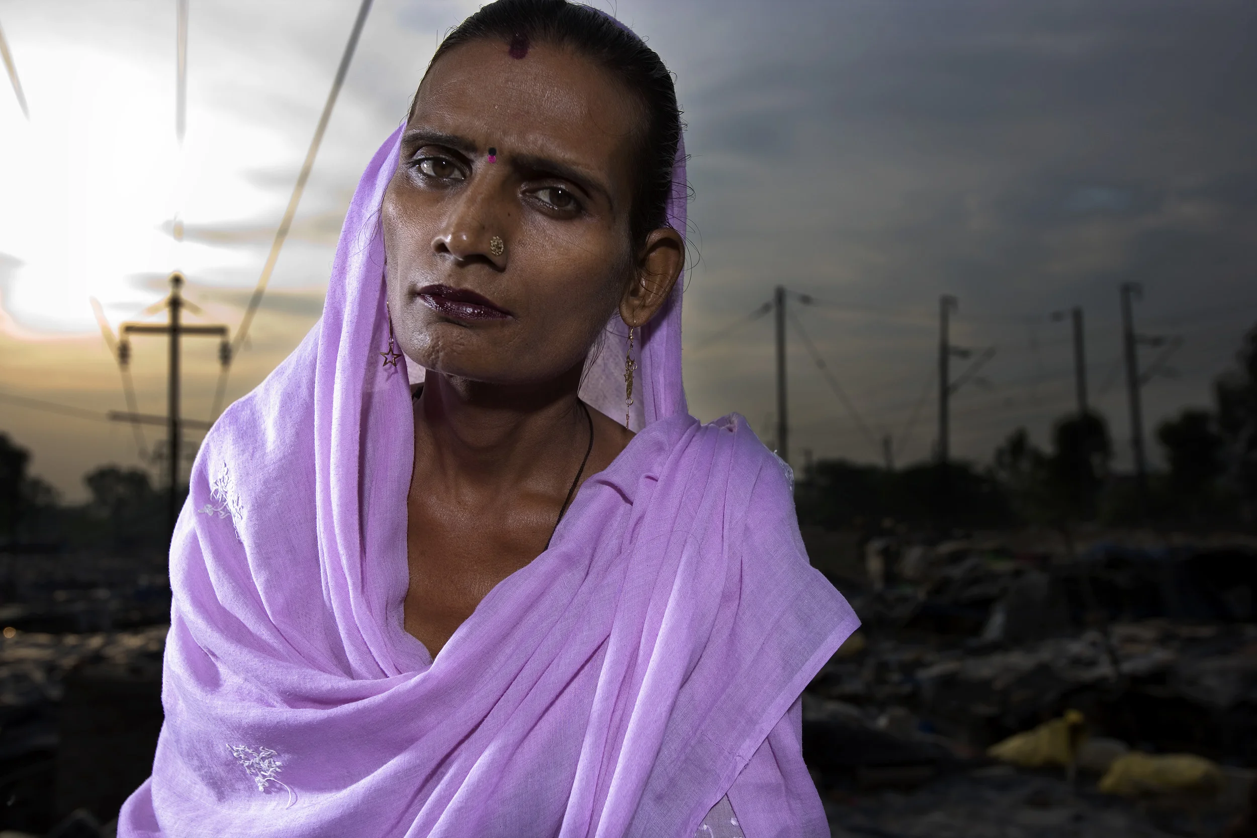 New Delhi, India, June 2006: Trans-gendered sex-workers photographed at their home in a slum in Delhi. These men live as women and are all HIV+. They have all been using IV drugs and are now being taken care of by Sahara, an Indian NGO. These trans-gendered men are all the primary means of support for their families. In two cases here the men support a wife, a boyfriend, as well as three kids. With only their bodies as sexual collateral they form a very high risk group.