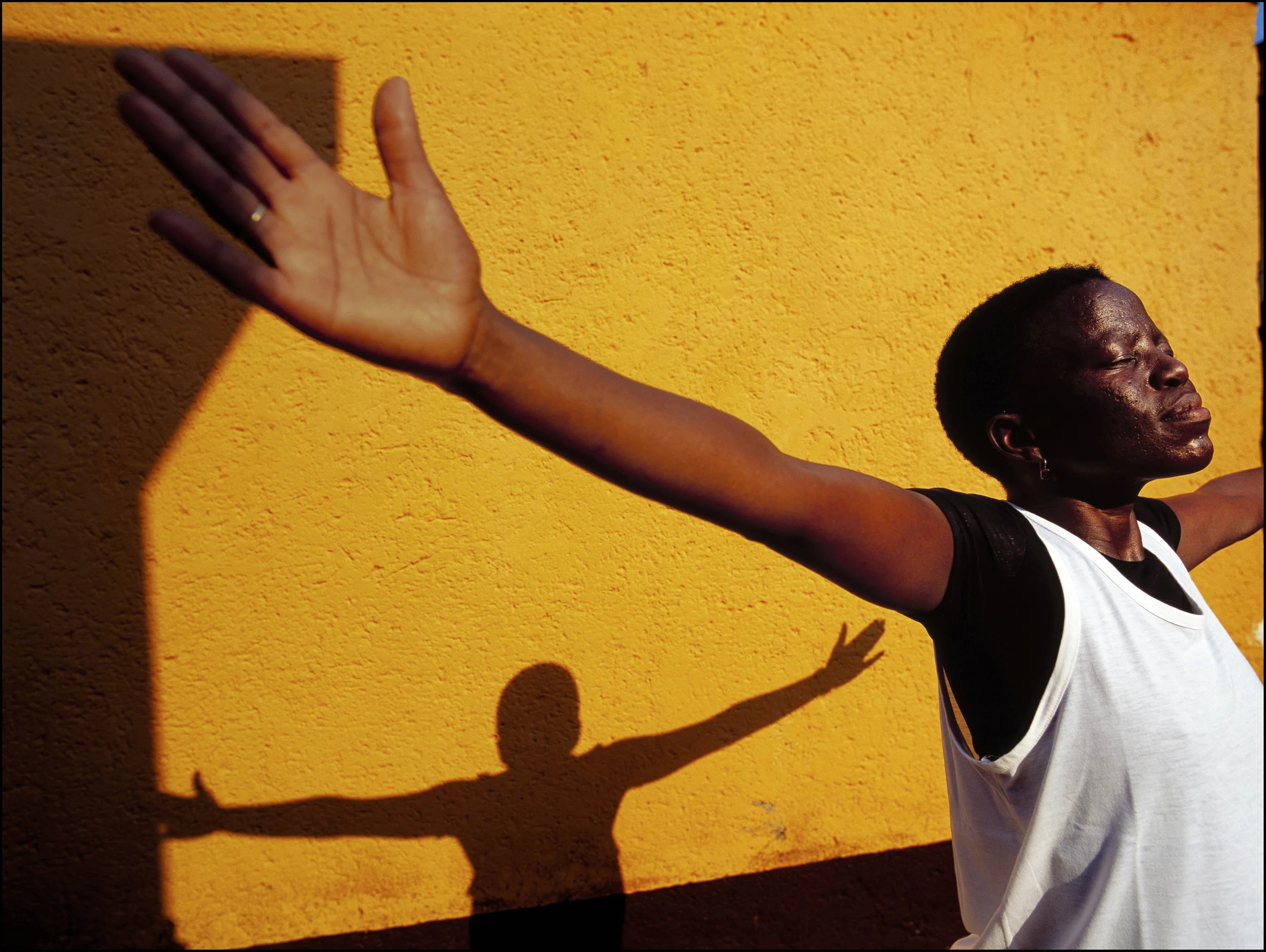 SOWETO SOUTH AFRICA-MAY 2005: An Hiv+ women on anti-retrovirals does her yoga routine in the garden of her home in Soweto township. Four months prior to this she was unable to walk and considered a final stage case. The access to medication has made her life possible again. PHOTO BY BRENT STIRTON/GETTY IMAGES