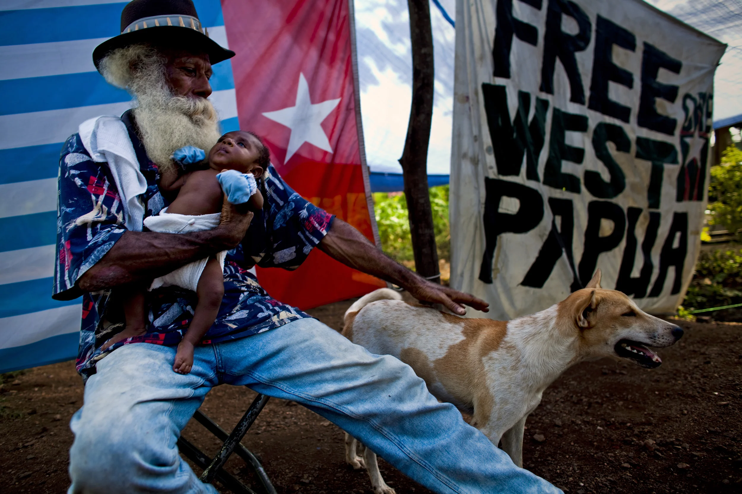 OUTSKIRTS OF PORT MORSEBY, PAPUA NEW GUINEA-DECEMBER 2008: Refugee members of the OPM Free West Papua movement in a refugee camp on the outskirts of Port Morseby, Papua New Guinea, 23 December 2008. Many here have been political refugees for over 30 years. OPM's followers have been against the Indoneasean colonisation of West Papua since 1969 when the Indonesean government rigged a vote in West Papua to have it included in Indonesean colonial property. Today West Papua forms the second largest component in Indonesea's economy and they control the mining and other natural resources of West Papua through the use of military force and the migration of Indoneaseans to West Papua. OPM is fighting for the international Community to recognise West Papuan independence which was recognised in 1971 but handed over to the Indoneseans in a rigged election. Today OPM continues to operate against the Indoneasean Army in the Jungles of West Papua but they are vastly outnumbers and out-gunned and many of their people have had to flee West Papua and try to live in PNG, not an easy task. This group have lived as refugees for over 30 years and continue to be moved on from the land on which they camp. They have had very little help and are already on a third generation of children born into these circumstances. Most of the men in this camp are active members of OPM or have been political prisoners under the Indoneseans. They continue to be targets of the Indonesean Army. (Photo by Brent Stirton/Reportage by Getty Images.)