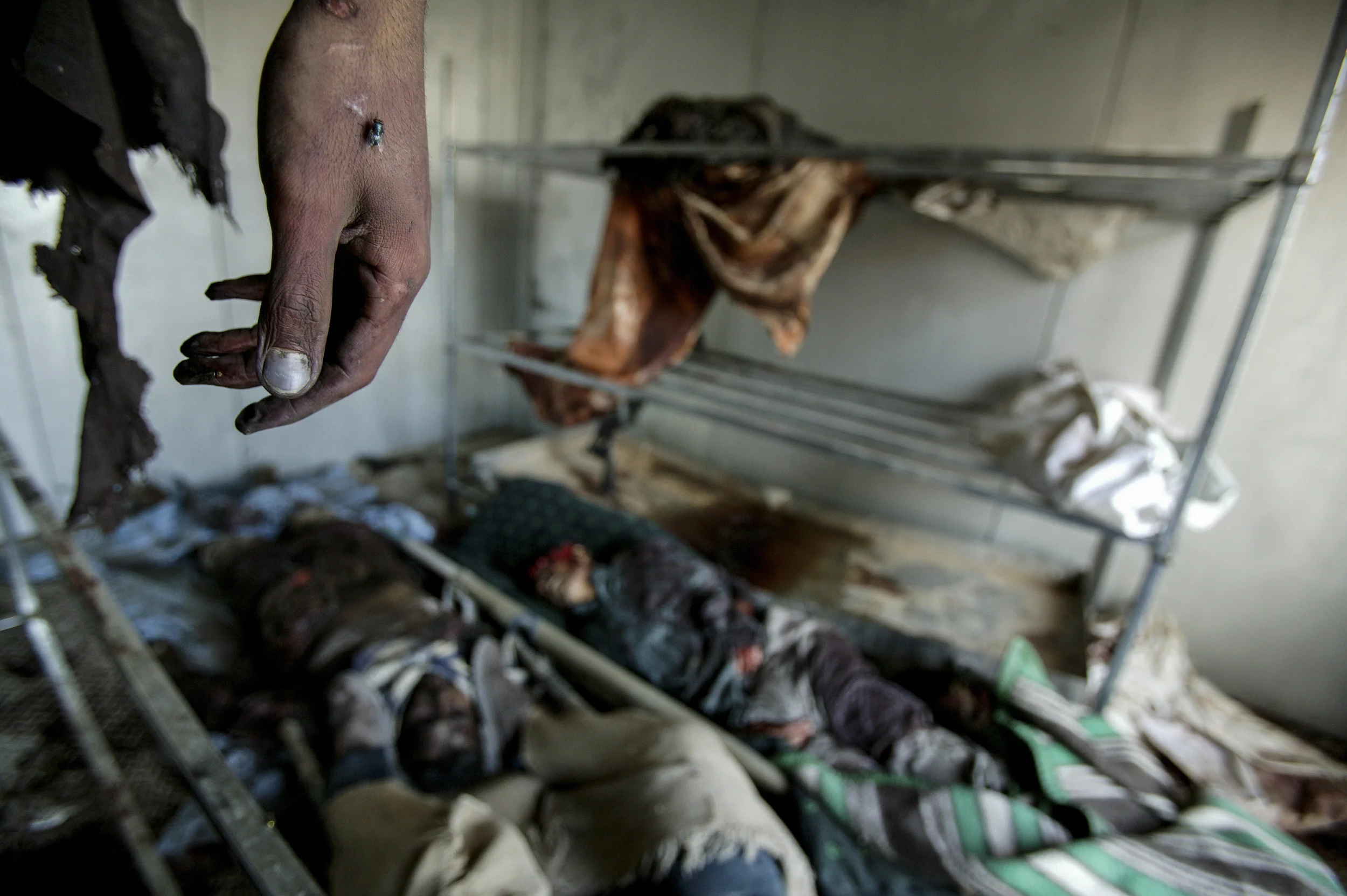 IRAQ, BAGHDAD. MAY 5 2004. BODIES OF IRAQI CIVILIANS LIE IN A MORGUE OUTSIDE OF BAGHDAD. THEY WERE KILLED IN AN ATTACK ON A TRUCK DRIVEN BY A MAN WHO WAS ACCUSED OF COLLABORATING WITH THE AMERICANS. *** Local Caption *** IRAQ