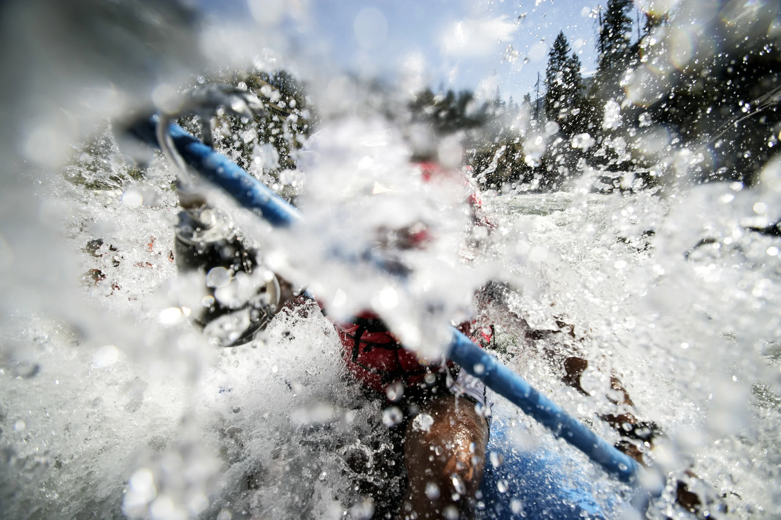 SALMON RIVER IDAHO - AUGUST 8/14 2006: Major Anthony L. Smith paddles through a wall of water using his prosthetic arm to propel the raft throught the water. He is one of three amputee veterans on a river trip down the Salmon River in Idaho. These images focus on a week in the life of three disabled war wounded veterans from the Iraq, Afghanistan conflicts. The three men are Major Anthony Smith,39, an African American man who was severely wounded in the hip in Iraq while on deployment. He is missing an arm, is recovering from 4 bullet wounds and has only partial use of his right leg and hip after being struck by an RPG. Damien Jocobs,30, is a Marine Staff Sergeant with a below the knee amputation as a result of an IED explosion in Iraq. Andy Soule, 25, is a specialist who was blown out os his vehicle by an IED in Afghanistan. Andy is a double above the knee amputee.
Higher Ground is a program run by Sun Valley Adaptive sports in Kethum Idaho. They are an NGO looking to provide a sports based meaningful rehabiliation experience for disabled veterans. The program involved taking the men, all of whom are amputees of sorts, down the Main Salmon River on a 4 day river rafting trip and then offering them the opportunity afterwards to pursue futher sporting intersts such as climbing, parasailing, kayaking and horse-riding. The program also encourages disabled veterans to bring their wives on the program. It is aimed at a healthier and speedier recovery through outdoor recreation.