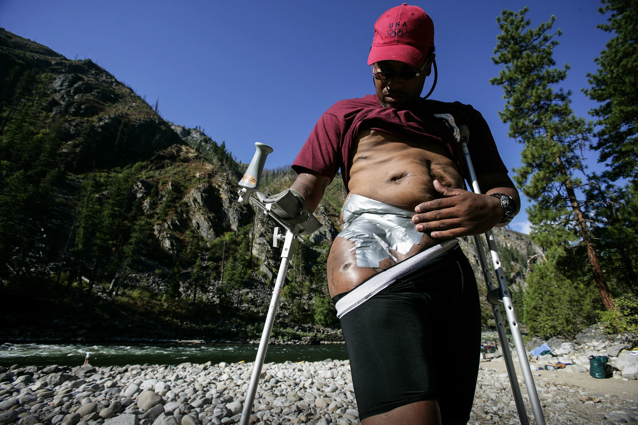 SALMON RIVER IDAHO - AUGUST 8/14 2006: Major Anthony L. Smith, 39, inspects his wounds after his wife Jacqueline Smith cleaned and applied new bandages at the end of the day on a river-rafting trip. The wound is still open and attempting to heal more than two years after the attack. These images focus on a week in the outdoors with three disabled war wounded veterans from the Iraq, Afghanistan conflicts. Major Anthony Smith,39, was severely wounded in the hip in Iraq while on deployment. He is missing an arm, is recovering from 4 bullet wounds and has only partial use of his right leg and hip after being struck by an RPG.
Higher Ground is a program run by Sun Valley Adaptive sports in Kethum Idaho. They are an NGO looking to provide a sports based meaningful rehabiliation experience for disabled veterans. The program involved taking the men, all of whom are amputees of sorts, down the Main Salmon River on a 4 day river rafting trip and then offering them the opportunity afterwards to pursue futher sporting intersts such as climbing, parasailing, kayaking and horse-riding. The program also encourages disabled veterans to bring their wives on the program. It is aimed at a healthier and speedier recovery through outdoor recreation.