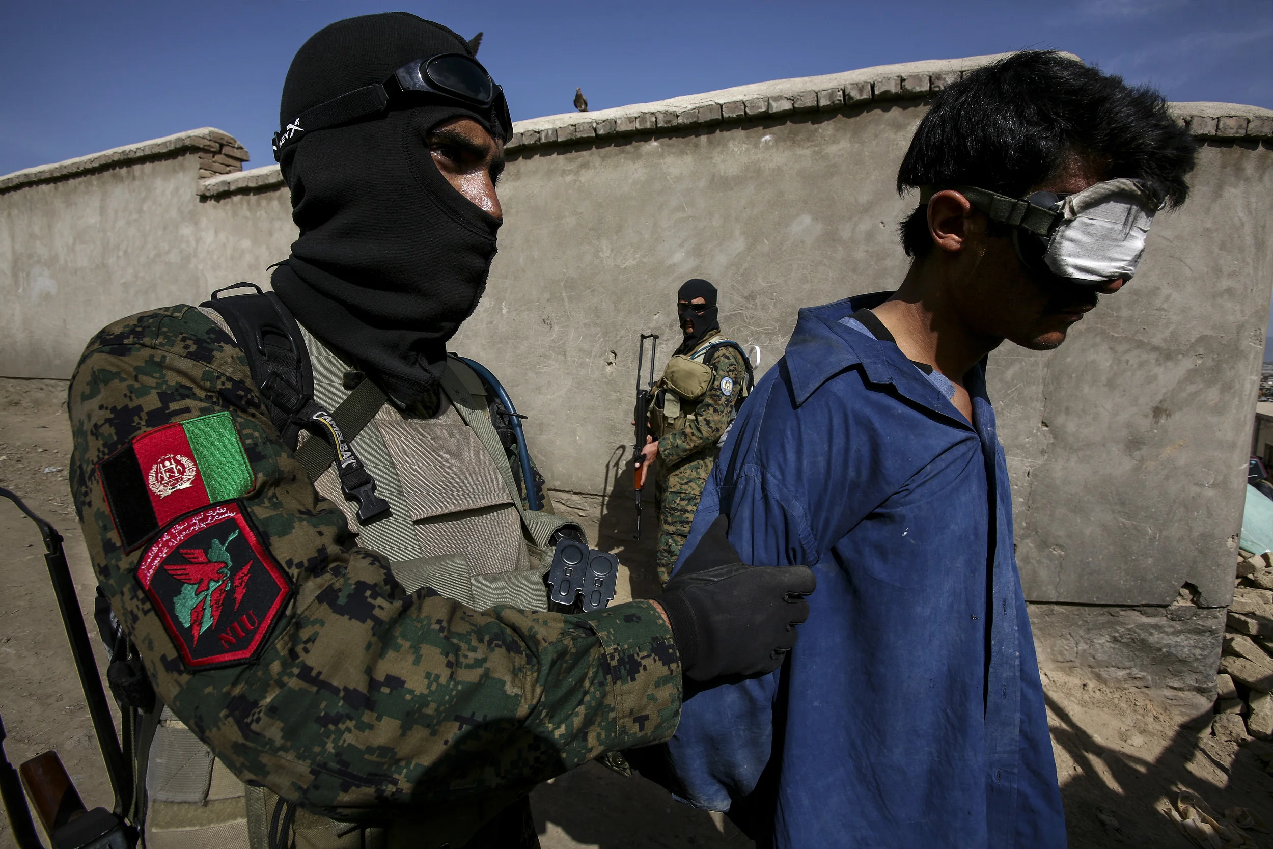 KABUL, AFGHANISTAN-APRIL 2007: Scenes from a drugs bust conducted by the Afghan Anti-Narcotics unit assisted by American DEA agents who have been training these men for over 2 years, Kabul, Afghanistan, 18 April 2007. The images show a search scene and arrest with 2 suspects in custody. 6 kilos of processed heroin was confiscated in the raid. Afghanistan currently produces over 90% of the world's illegal opium and the industry accounts for over 45% of the countries annual GDP. A great deal of this production is based on communal poverty and a lack of alternatives for farmers combined with coercion from the opium cartels of Afghanistan and Pakistan. The event is filmed by CNN freelance crew Cameraman Richard Parry and producer Tresha Mabile. (Photo by Brent Stirton/Getty Images.)