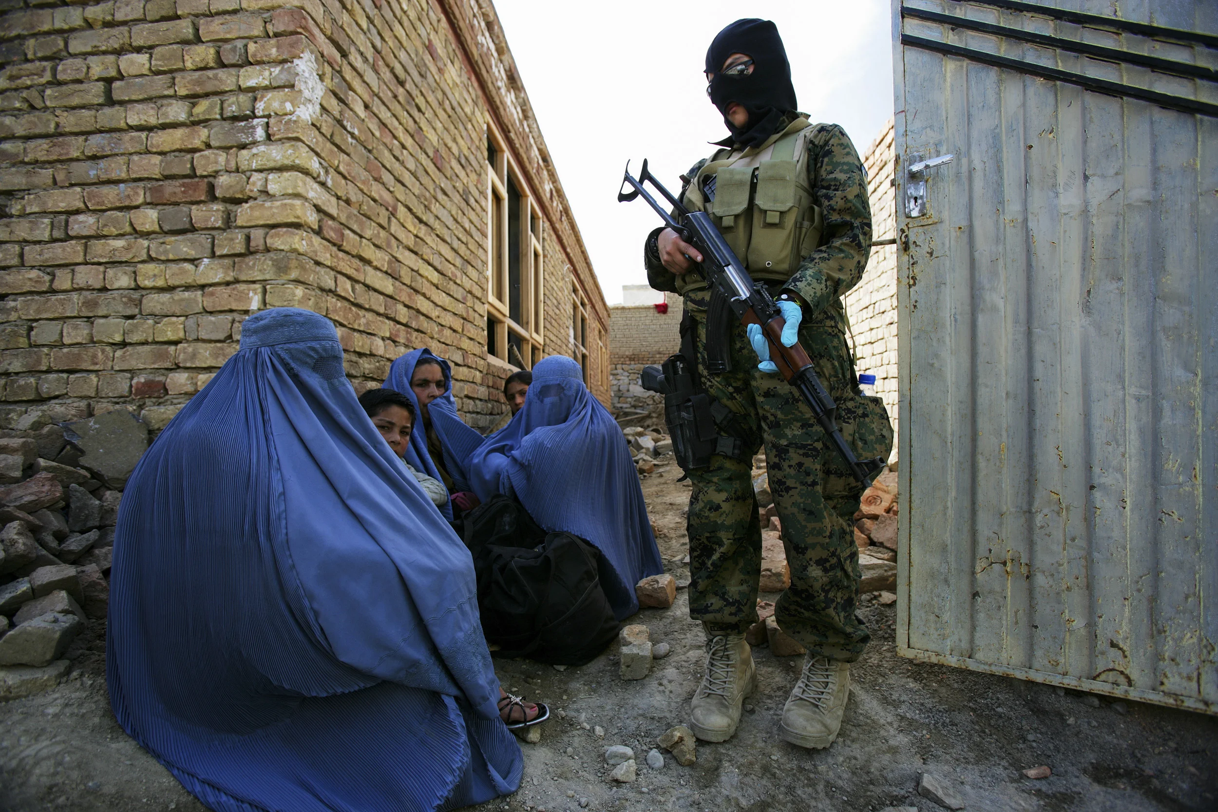 KABUL, AFGHANISTAN-APRIL 2007: Scenes from a drugs bust conducted by the Afghan Anti-Narcotics unit assisted by American DEA agents who have been training these men for over 2 years, Kabul, Afghanistan, 18 April 2007. The images show a search scene and arrest with 2 suspects in custody. 6 kilos of processed heroin was confiscated in the raid. Afghanistan currently produces over 90% of the world's illegal opium and the industry accounts for over 45% of the countries annual GDP. A great deal of this production is based on communal poverty and a lack of alternatives for farmers combined with coercion from the opium cartels of Afghanistan and Pakistan. The event is filmed by CNN freelance crew Cameraman Richard Parry and producer Tresha Mabile. (Photo by Brent Stirton/Getty Images.)