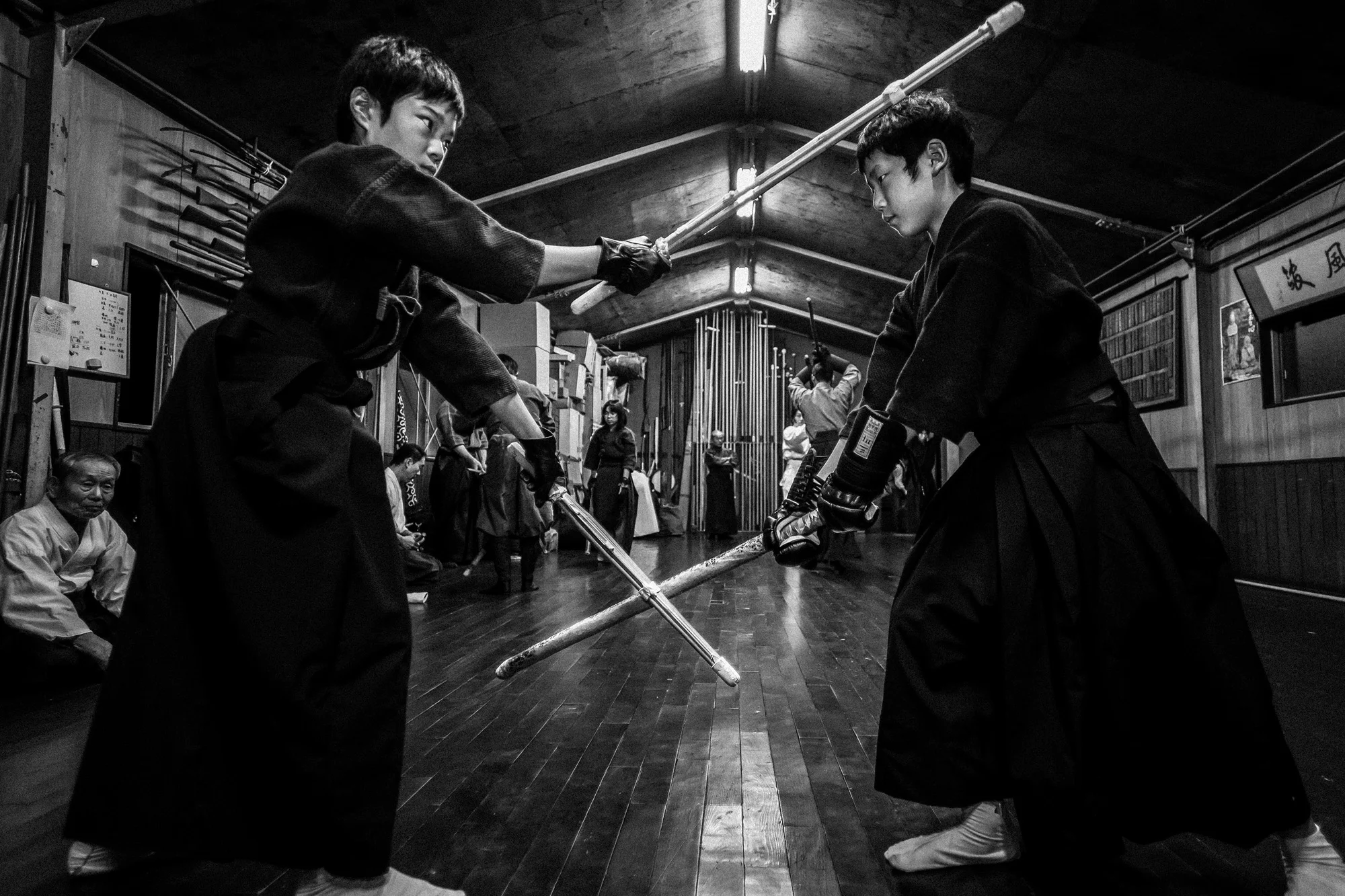 NAGOYA CITY, JAPAN, 17 OCTOBER 2014: The dojo of Master Sensei Kato, 81, who runs the Owari Kan Ryu school where he himself studied under his master from the age of 25. Kato is a traditionalist and showed his family Scrolls, the way of the Samurai, which date back to the 15th century. Kato has a number of foreign students, including Alex Krupp, a dedicated American from Boston. Kato-sensei was born in Tokyo. He began Aikido training in 1954 at Aikido World Headquarters (Hombu Dojo) under the instruction of the Founder of Aikido, Morihei Ueshiba otherwise known as O’Sensei. Introduced to the Aikikai Hombu Dojo through his mother’s network of connections when he was 19, he trained there daily as well as spending long hours perfecting his personal practice. Working during the day as a printer, he attended classes at night, and for this reason he was unable to be an uchideshi, and does not appear in early photographs with them. He continued to train for over 52 years at the Aikikai Hombu Dojo although he later primarily taught at his Suginami Dojo, but he still attended special events at Aikikai Hombu dojo. After his first 10 years at Hombu Dojo, Kato-sensei occasionally had chances to personally serve the Founder. He is still pursuing Aikido through the Founder’s image, as according to Kato-sensei, “To me, the Founder is not dead. He is still alive in my mind and in my heart.” Kato attended Doshu’s class over three generations: the Founder, the second Doshu, and the current third Doshu. He received his first six black belts from the Founder and his next two black belts from the second Doshu.
His self-training in Aikido has been ascetic. In his early years, he often used to practice weapons by himself through the night, greet sunrise the next morning, and then go to work again. Kato's Aikido had a measure of personal spirituality to it. Before every class, Kato Sensei arrived early to the dojo to meditate. Since he was young, he visited mountain shrines and