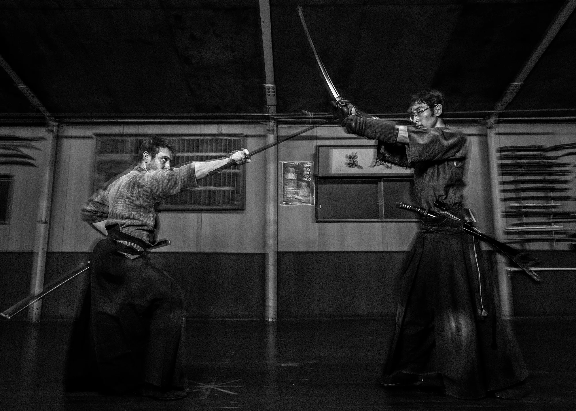 NAGOYA CITY, JAPAN, 17 OCTOBER 2014: The dojo of Master Sensei Kato, 81, who runs the Owari Kan Ryu school where he himself studied under his master from the age of 25. Kato is a traditionalist and showed his family Scrolls, the way of the Samurai, which date back to the 15th century. Kato has a number of foreign students, including Alex Krupp, a dedicated American from Boston. Kato-sensei was born in Tokyo. He began Aikido training in 1954 at Aikido World Headquarters (Hombu Dojo) under the instruction of the Founder of Aikido, Morihei Ueshiba otherwise known as O’Sensei. Introduced to the Aikikai Hombu Dojo through his mother’s network of connections when he was 19, he trained there daily as well as spending long hours perfecting his personal practice. Working during the day as a printer, he attended classes at night, and for this reason he was unable to be an uchideshi, and does not appear in early photographs with them. He continued to train for over 52 years at the Aikikai Hombu Dojo although he later primarily taught at his Suginami Dojo, but he still attended special events at Aikikai Hombu dojo. After his first 10 years at Hombu Dojo, Kato-sensei occasionally had chances to personally serve the Founder. He is still pursuing Aikido through the Founder’s image, as according to Kato-sensei, “To me, the Founder is not dead. He is still alive in my mind and in my heart.” Kato attended Doshu’s class over three generations: the Founder, the second Doshu, and the current third Doshu. He received his first six black belts from the Founder and his next two black belts from the second Doshu.
His self-training in Aikido has been ascetic. In his early years, he often used to practice weapons by himself through the night, greet sunrise the next morning, and then go to work again. Kato's Aikido had a measure of personal spirituality to it. Before every class, Kato Sensei arrived early to the dojo to meditate. Since he was young, he visited mountain shrines and