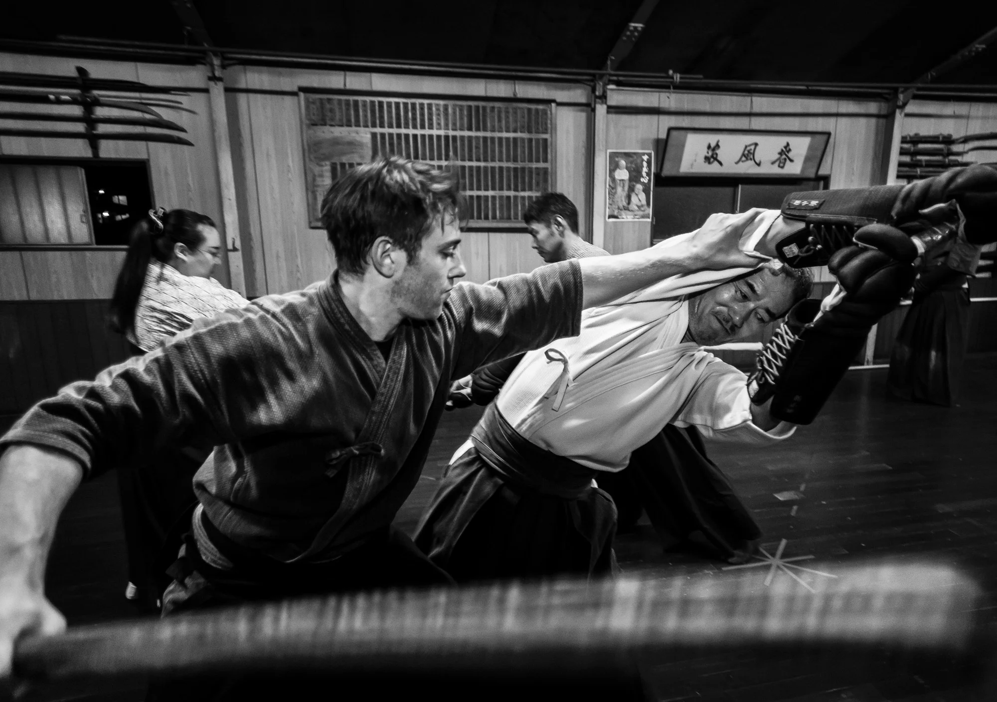 NAGOYA CITY, JAPAN, 17 OCTOBER 2014: Alex Krupp, a dedicated American from Boston, practises Samurai Bushido skills in the dojo of Master Sensei Kato, 81, who runs the Owari Kan Ryu school where he himself studied under his master from the age of 25. Kato is a traditionalist and teaches techniques in the way of the Samurai that date back to the 15th century. Kato has a number of foreign students, the skills of the Samurai have continued to draw these students from all over the world.
