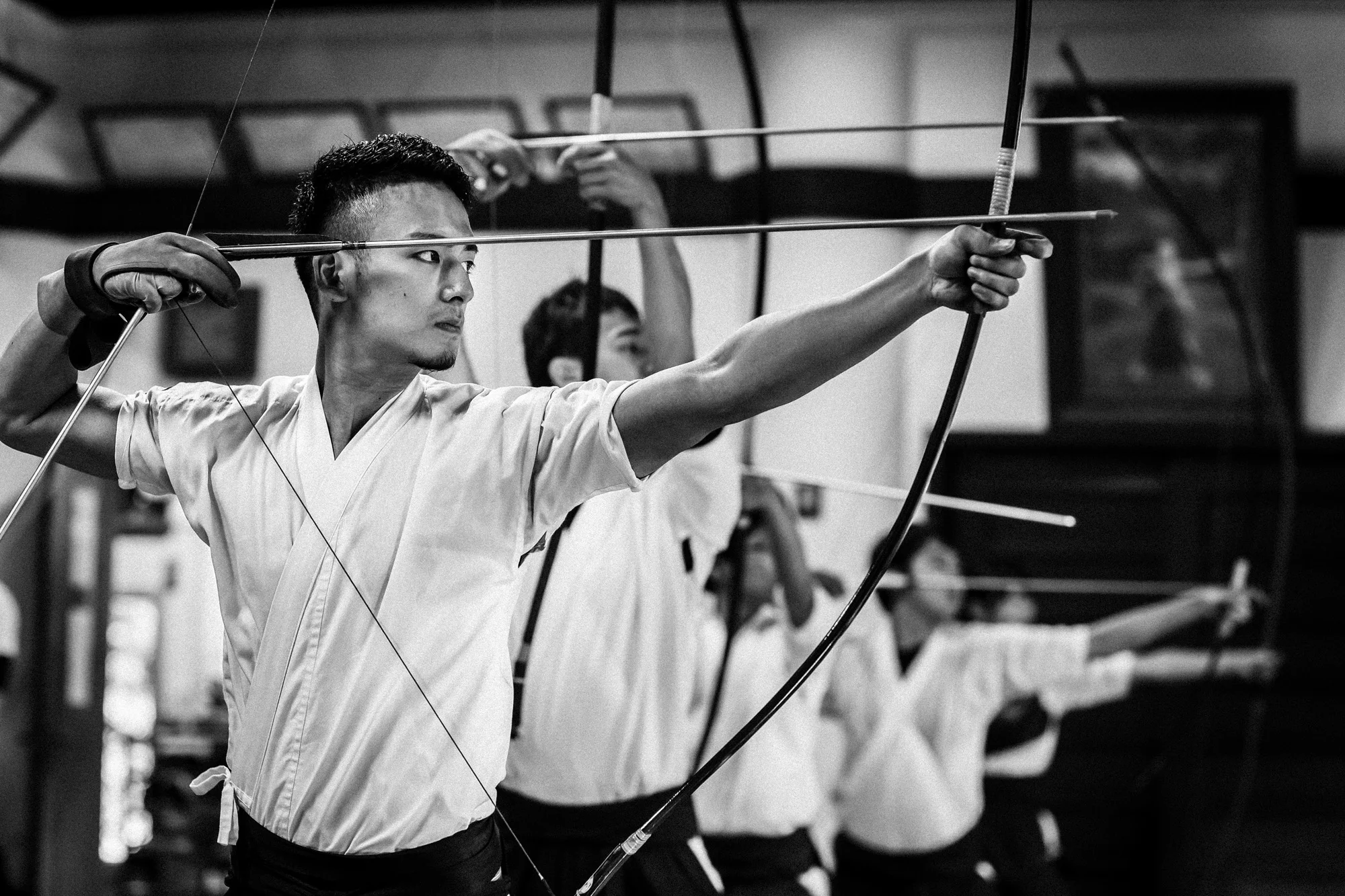 TOKYO UNIVERSITY, TOKYO, JAPAN, 25 OCTOBER 2014: Tokyo University Kyudo club in action at the University dojo, Tokyo, Japan. Kyudo is much more a moving meditation than a sport of archery, with an emphasis on breath, perfection of movement than an attempt to hit the target. It is seen as one of the most static of the Bushido Samurai arts. These young students all talk about the beauty and the meditative aspects of the sport and not the actual target shooting. All of the Samurai arts have aspects which stress these points of technique, artistry and flow. (Photo by Brent Stirton/Reportage by Getty Images for Le Figaro.)
