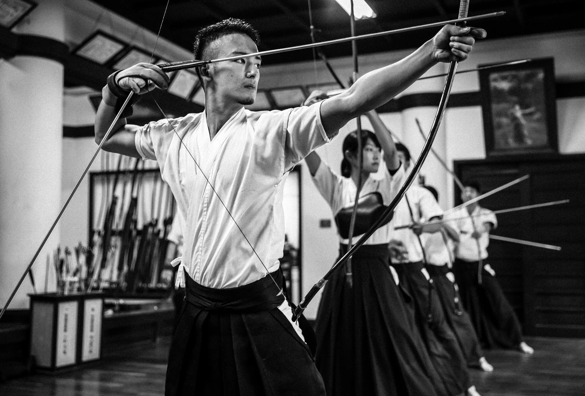 TOKYO UNIVERSITY, TOKYO, JAPAN, 25 OCTOBER 2014: Tokyo University Kyudo club in action at the University dojo, Tokyo, Japan. Kyudo is much more a moving meditation than a sport of archery, with an emphasis on breath, perfection of movement than an attempt to hit the target. It is seen as one of the most static of the Bushido Samurai arts. These young students all talk about the beauty and the meditative aspects of the sport and not the actual target shooting. All of the Samurai arts have aspects which stress these points of technique, artistry and flow. (Photo by Brent Stirton/Reportage by Getty Images for Le Figaro.)