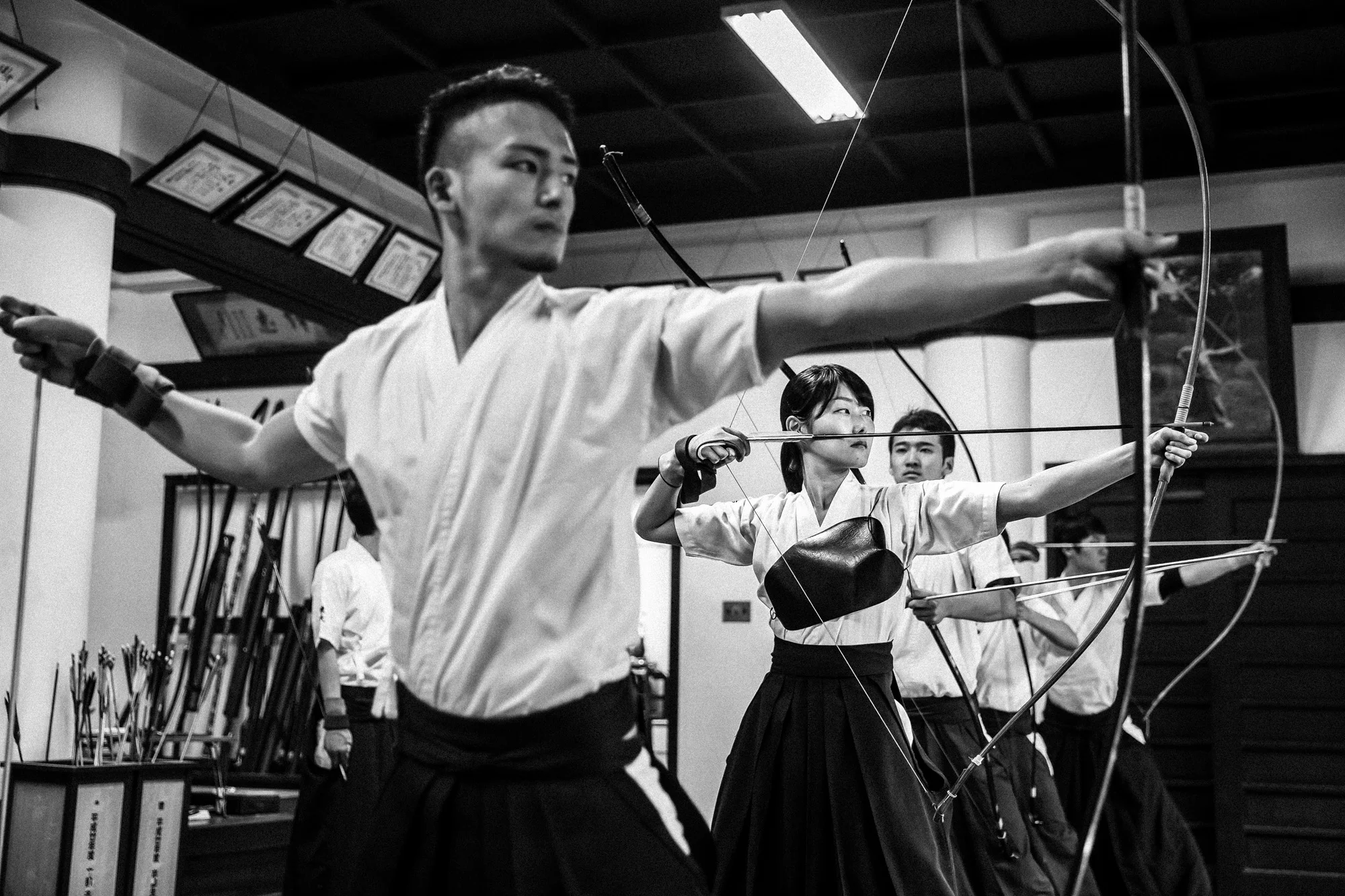 TOKYO UNIVERSITY, TOKYO, JAPAN, 25 OCTOBER 2014: Tokyo University Kyudo club in action at the University dojo, Tokyo, Japan. Kyudo is much more a moving meditation than a sport of archery, with an emphasis on breath, perfection of movement than an attempt to hit the target. It is seen as one of the most static of the Bushido Samurai arts. These young students all talk about the beauty and the meditative aspects of the sport and not the actual target shooting. All of the Samurai arts have aspects which stress these points of technique, artistry and flow. (Photo by Brent Stirton/Reportage by Getty Images for Le Figaro.)