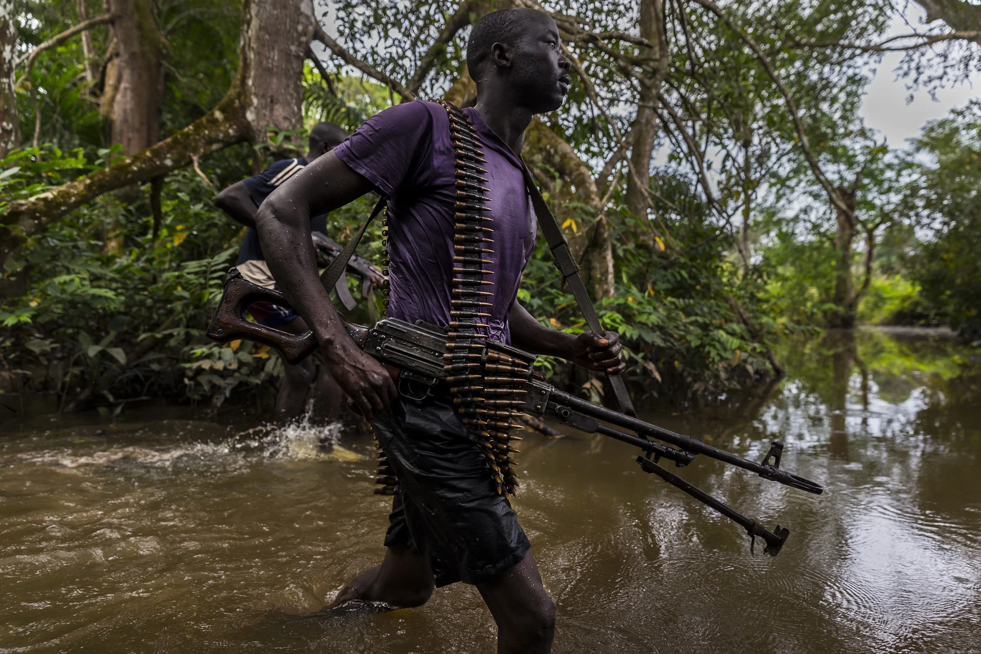 MBOKI, CENTRAL AFRICAN REPUBLIC, 25 NOVEMBER 2014: Soldiers on patrol from the African Union Ugandan Armed forces, UPDF, base at Mboki, Central African Republic. The Ugandan contingent based here are focused on the aprehension of the Lord's Resistance Army, LRA, the notorious rebel group led by Joseph Kony which has terrorized citizens of Uganda, C.A.R, South Sudan and the Democratic Republic of Congo for the last 4 decades. Soldiers are seen crossing a river, a technique they have perfected with ropes despite the fact that many of the men cannot swim. Captain (Photo by Brent Stirton/Reportage by Getty Images for National Geographic Magazine.)