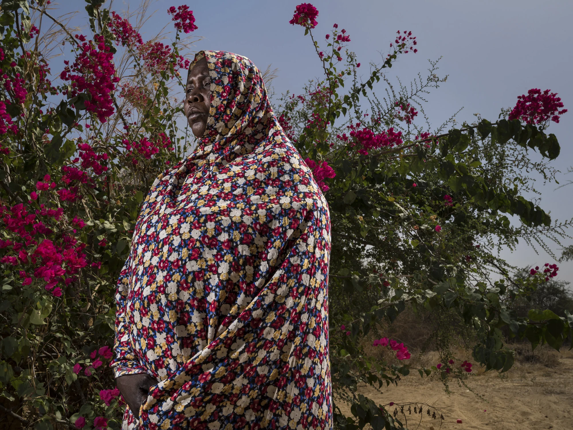 ZAKOUMA NATIONAL PARK, CHAD, 7 JANUARY 2015: Ranger widow Hawa Oumar photographed inside Zakouma National Park, Chad. Hawa lost her husband in the attack on Heban which occured on 2 September 2012. Hawa has 7 children to care for and works as a farmer and weaver to support them. 6 Rangers died in the attack in total, leaving 48 children in total fatherless. These widows believe Zakouma is worth protecting and that the park could play a role for all the surrounding community. They feel the sacrifice of their men was worth it but would feel better if there was some guarantee of protection for their children in the event of death in the course of Ranger duties. (Photo by Brent Stirton/Reportage for National Geographic Magazine.)