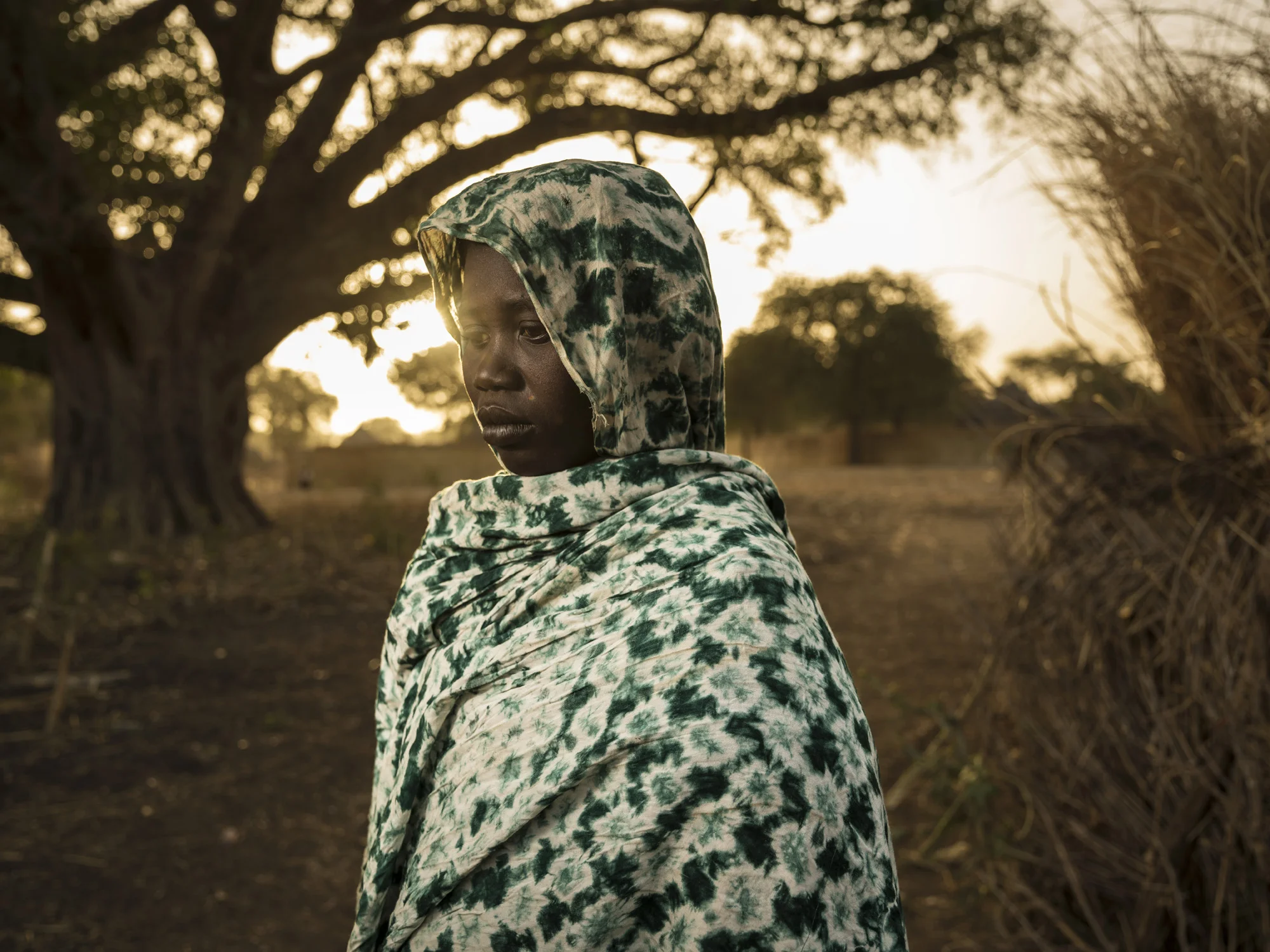 ZAKOUMA NATIONAL PARK, CHAD, 9 JANUARY 2015: Ranger widow Alice Mohammed photographed inside Zakouma National Park, Chad. Hawa lost her husband in the attack on Heban which occured on 2 September 2012. Alice has 8 children to care for and works as a farmer and weaver to support them. 6 Rangers died in the attack in total, leaving 48 children in total fatherless. These widows believe Zakouma is worth protecting and that the park could play a role for all the surrounding community. They feel the sacrifice of their men was worth it but would feel better if there was some guarantee of protection for their children in the event of death in the course of Ranger duties. (Photo by Brent Stirton/Reportage for National Geographic Magazine.)