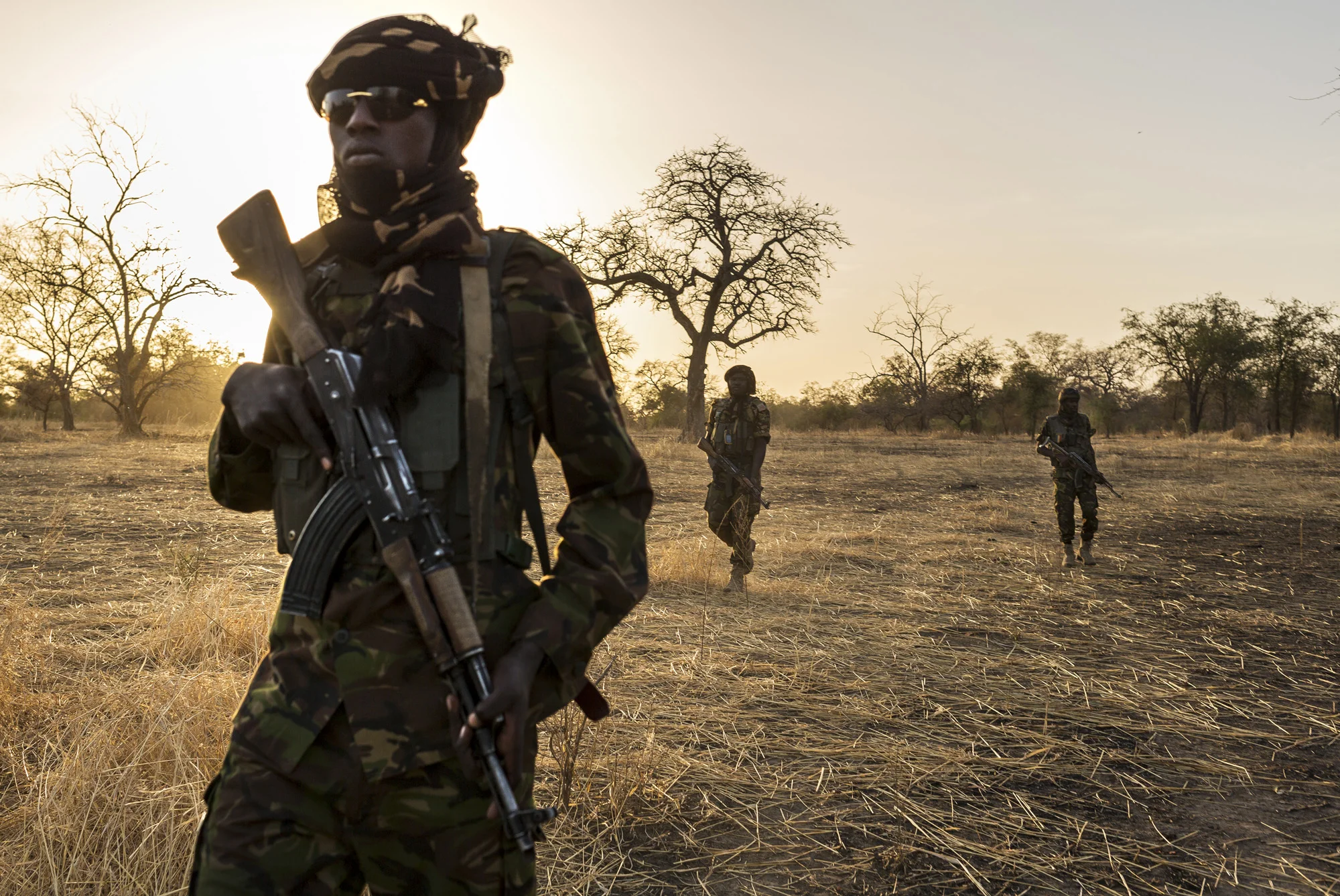 ZAKOUMA NATIONAL PARK, CHAD, 10 JANUARY 2015: Zakouma Rangers "Mamba Team 1" seen inside the park during one of their anti-poaching patrols. Driver Issa Idriss Adoum, wearing the brown shirt, lost his Ranger father in an attack which killed 6 Rangers in 2012. Those men were gunned down by Sudanese elephant poachers. Issa's uncle, his fathers brother, alerted a combined Chadian Sudanese border force and went into Sudan to retrieve one of the poachers who was involved in the killings. Issa refused a government pay out for the loss, stating it was a death that needed to be avenged through justice or death. The poacher was imprisoned in Chad but escaped and is rumored to have joined the Seleka, an C.A.R movement with connections to elephant killing. (Photo by Brent Stirton/Reportage for National Geographic Magazine.)
