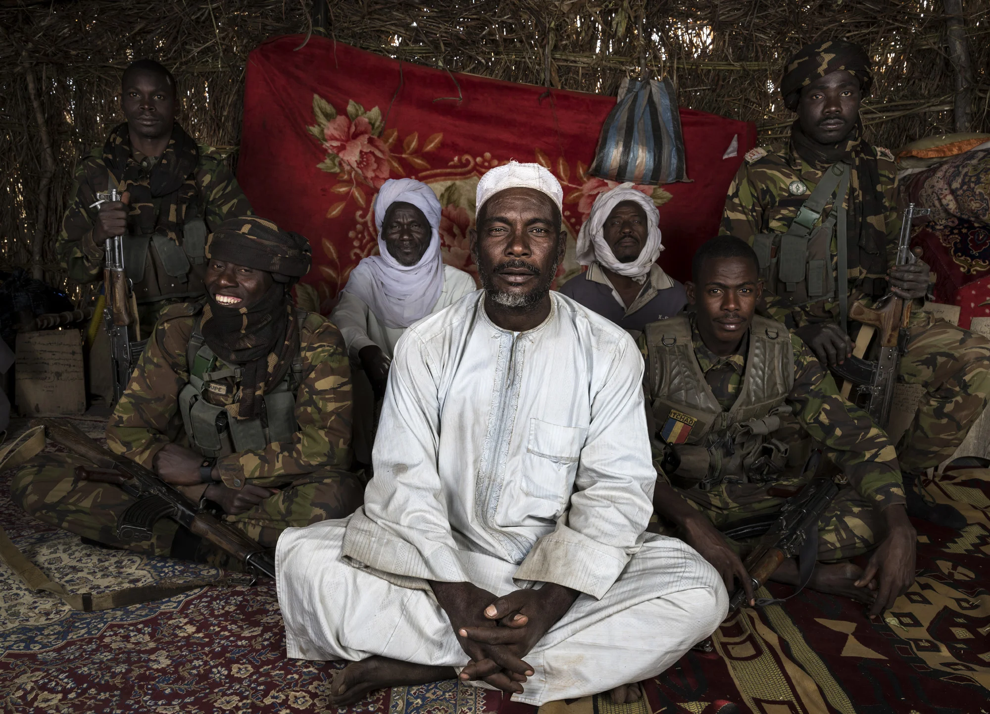 NANDUMA, CHAD, 12 JANUARY 2015: Zakouma National Park Rangers interact easily with the men of a Nomad camp close to Zakouma National Park. The Park has developed good relations with the nomads and they share an intelligence network which has helped to prevent poaching. A number of Rangers come from these communities and have close ties. Zakouma is recovering from a ten year period where from 2012 to 2012 they lost 90% of their elephants, almost 4000 elephant. (Photo by Brent Stirton/Reportage for National Geographic Magazine.)