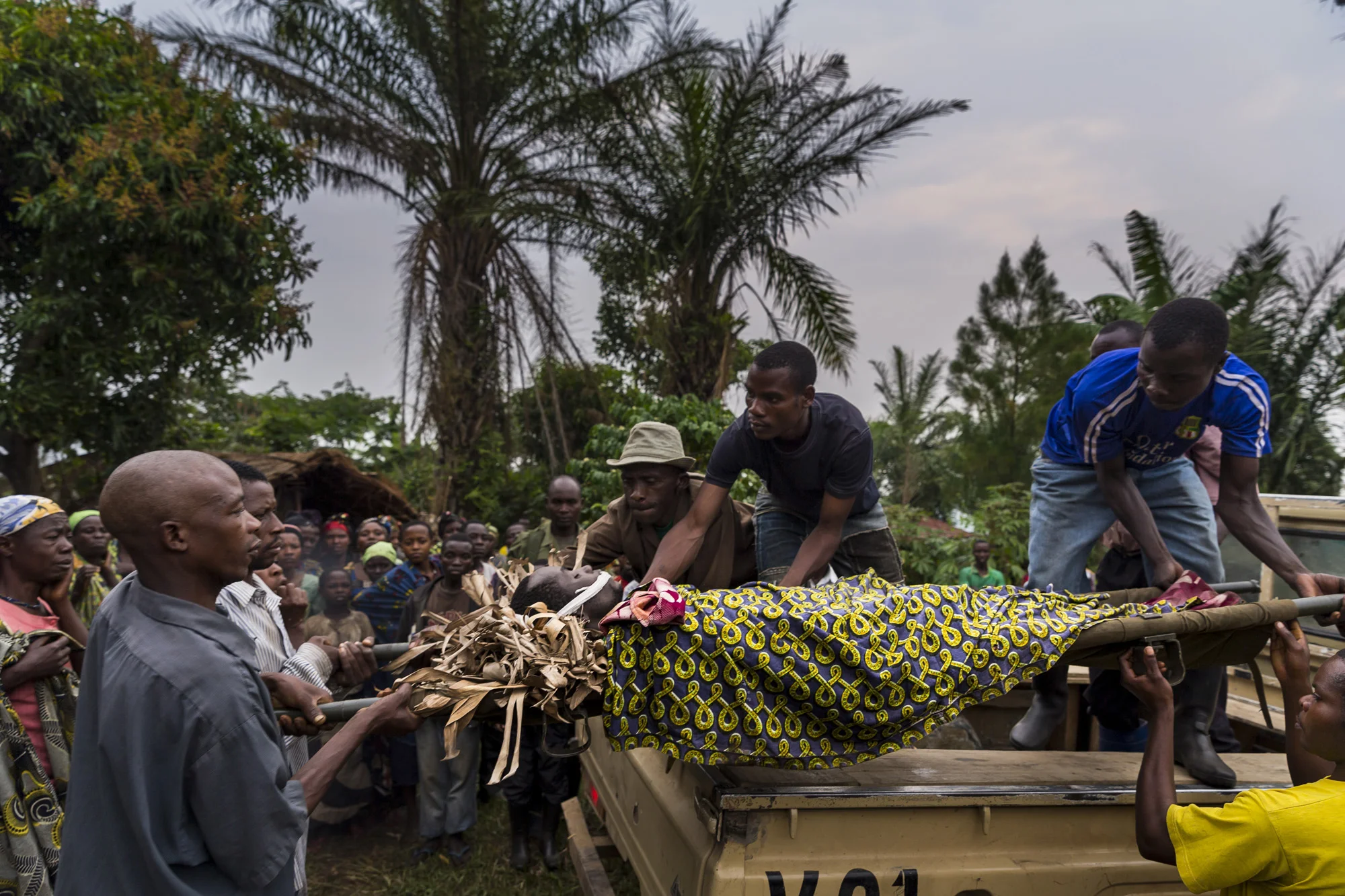SARAMBE, EASTERN CONGO, 21 JULY 2014: People grieve over the death of a deputy ranger who was killed for trying to prevent illegal agriculture inside Virunga National Park, Eastern DR Congo. It is suspected that he was shot by FDLR members, the Hutu rebel group who has been living inside and exploiting Virunga NP since 1994. FDLR control certain sections of Virunga and conduct illegal agricultural activities which devastate the environment for the animals. This man's widow will be looked after as part of a ICCN rangers plan which attempts to provide support for widows of men who died in service of the park. 190 men have been killed in their duties in the last 15 years. (Photo by Brent Stirton/Reportage. )