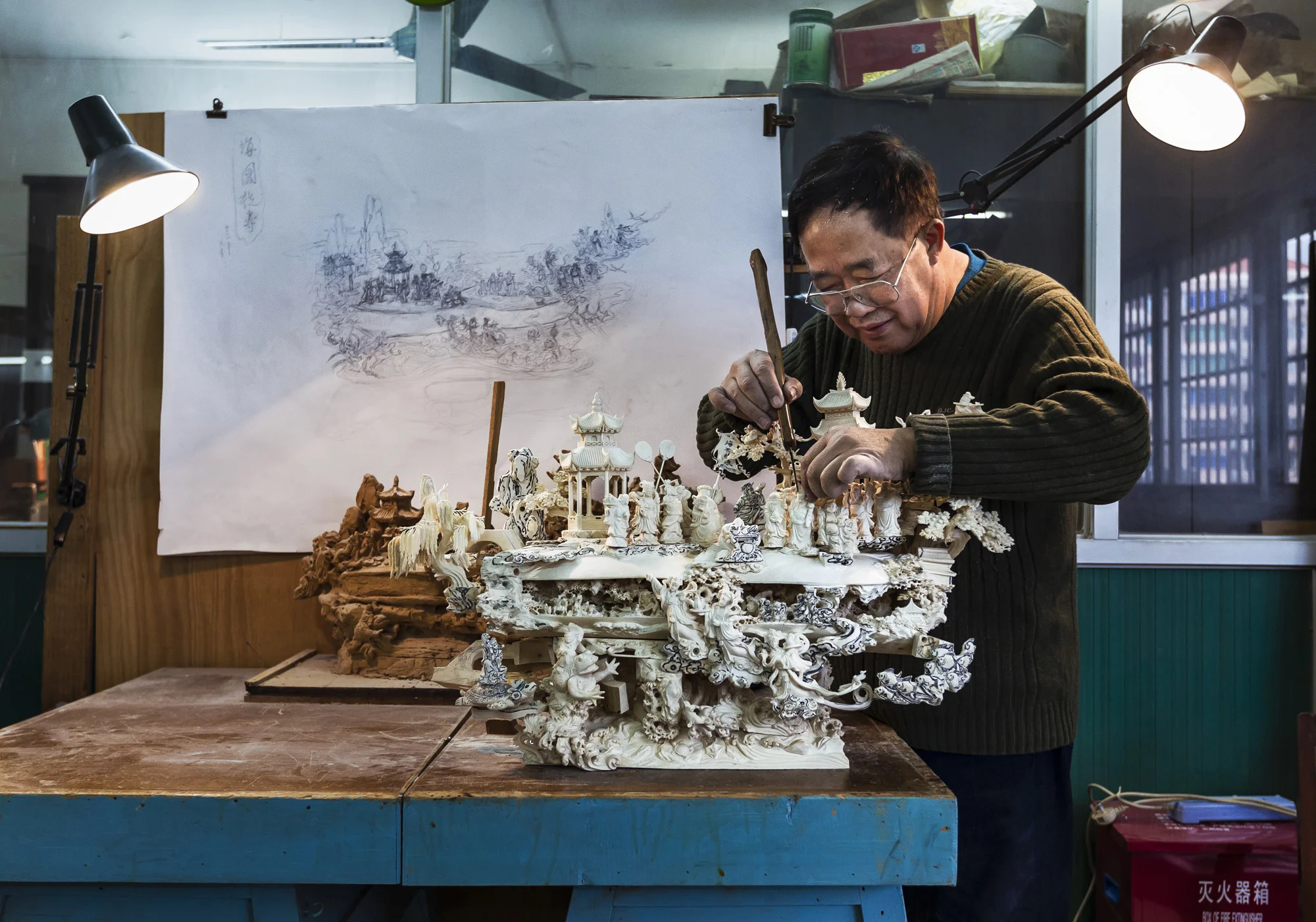 GUANGZHOU, CHINA, FEBRUARY 2012: The majority of ivory makes its way to China, by far the largest consumer on earth. In this image ivory carver Wu Rong Chang, 67, who has been carving for 50 years, is seen working on a large Ivory carving at the Guangzhou Daxin Ivory Carving Factory, a state owned enterprise specialising in the ivory carving businessin the People's Republic of China, Guangzhou, February 4 2012. Daxin specialising in the Hollow Ball carving of 25 layers, large landscape ivory hillocks and also works with Mamoth Ivory. (Photo by Brent Stirton/Reportage for National Geographic Magazine.)