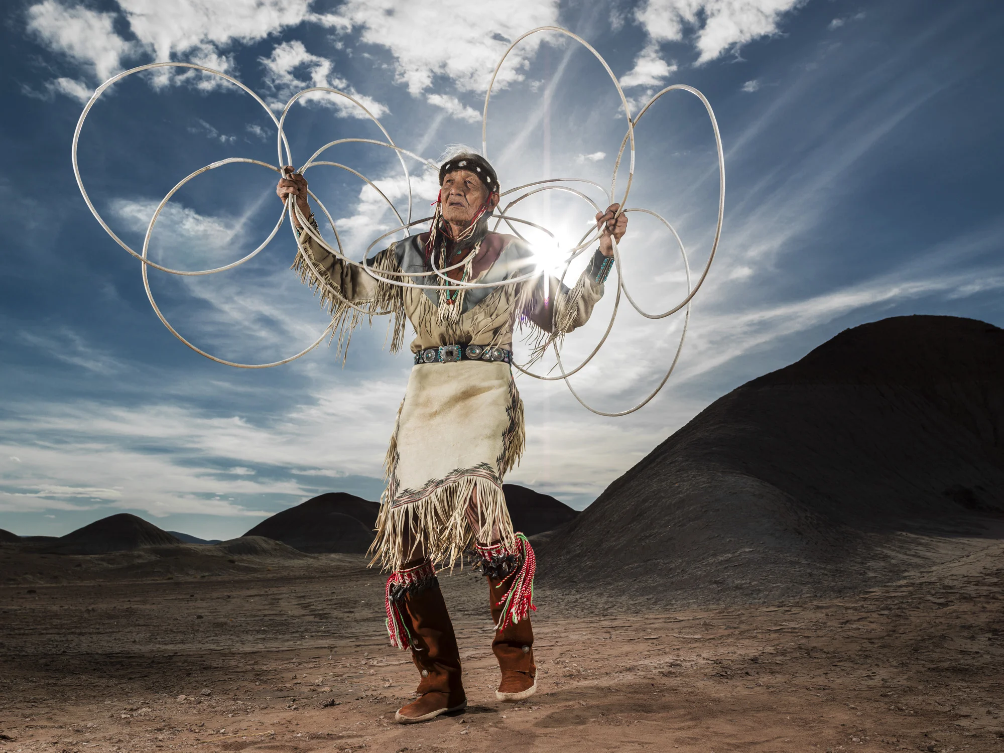 CAMERON, ARIZONA, 16 APRIL 2014: Jones Benally, a famous medicine man, dances the Navajo Hoop dance in a small canyon in the badlands of Cameron, Arizona. The hoop dance is traditionally performed at the end of a grueling nine day ceremony and is a form of storytelling dance representing various animals, symbols and storytelling elements, all representing the never ending circle of life for the Navajo. (Photo by Brent Stirton/Reportage for Le Figaro Magazine.)