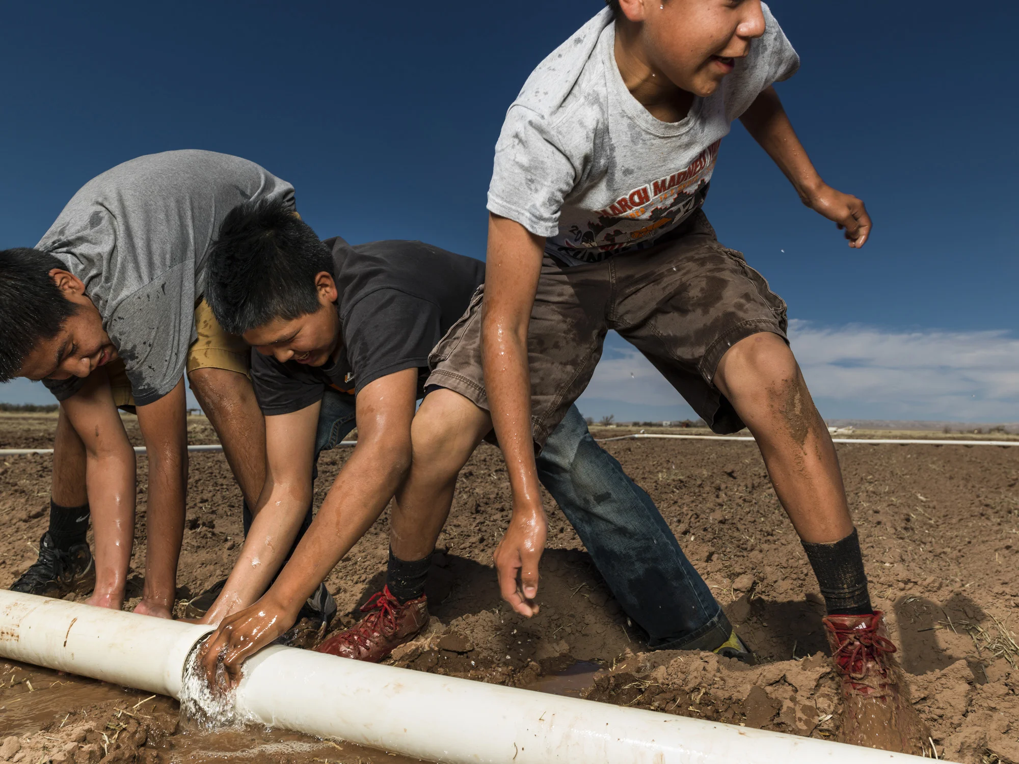 LEUP, ARIZONA, 10 APRIL 2014: Kids from the progressive Star charter school in Leup Arizona attend communal agriculture classes at the Leup Communal farm. The Star school runs completely off the grid and has a Montessori style teaching schedule with a strong emphasis on Navajo Cultural values. The school has a very high success rate with its students with a 71% graduation rate compared to only 1% for Native pupils at Arizona state schools. Despite this, there is a movement to close Native schools in Arizona due to an unfair ratings system which does not take into account reservation issues and Navajo based teaching techniques. (Photo by Brent Stirton/Reportage for Le Figaro.)