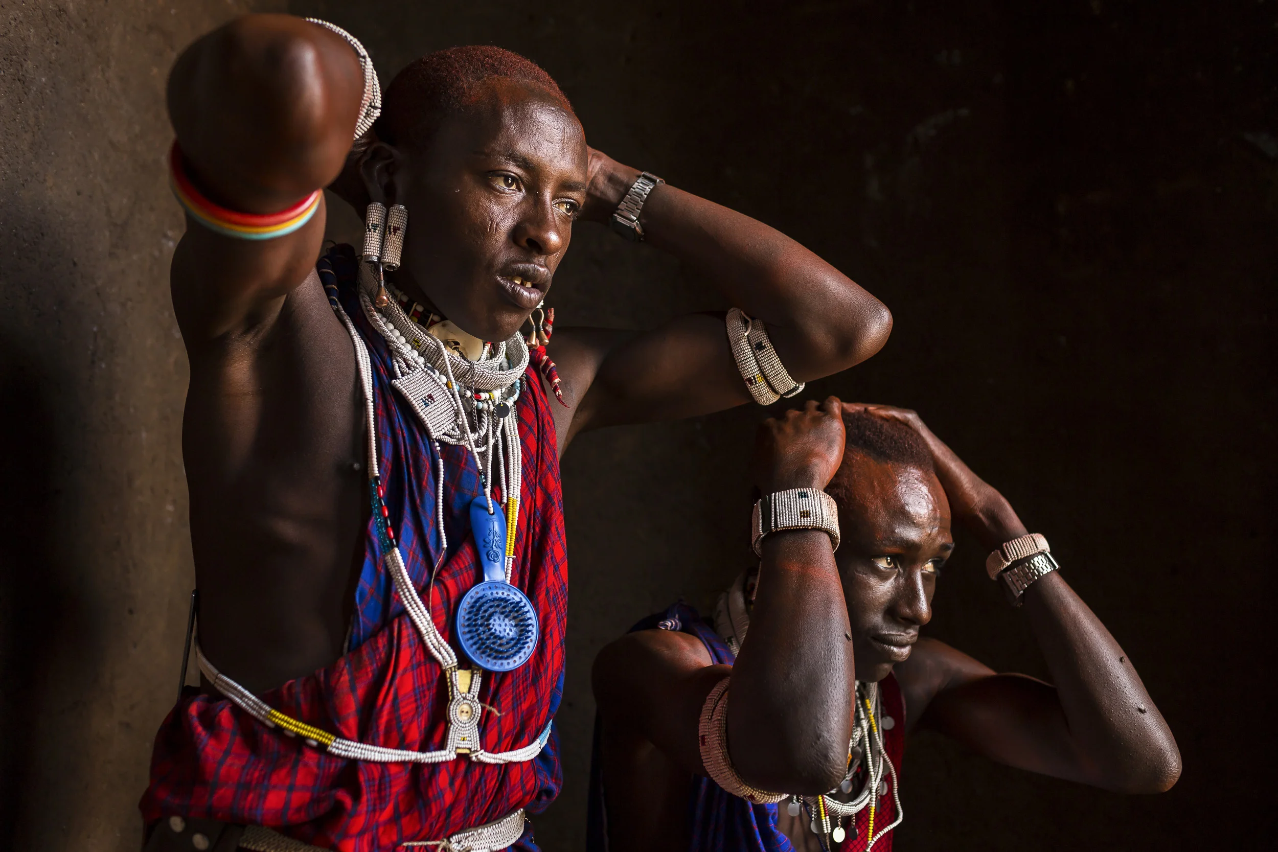LOLIONDO, NORTHERN TANZANIA, NOVEMBER 2012: Images from a Masai coming –of-age ceremony in a remote Masai village in Loliondo, Northern Tanzania, 2 November 2012. Two of the young warriors in this ceremony are wearing a Lion Mane head-dress from a lion they speared 3 years ago. The Masai have a long history of lion-killing, both as a proving ground for young warriors in their ascent to manhood and also to protect their cattle from lion attacks. This is an illegal activity and 3 years ago a number of young warriors were arrested and jailed for this offence. Illegal lion killing continues amongst the Masai today, but as lion numbers dwindle, this activity is also increasingly rare to find. Conflict between the pastoralist Masai and the lion is an age-old phenomenon. (Photo by Brent Stirton/Reportage for National Geographic Magazine.)