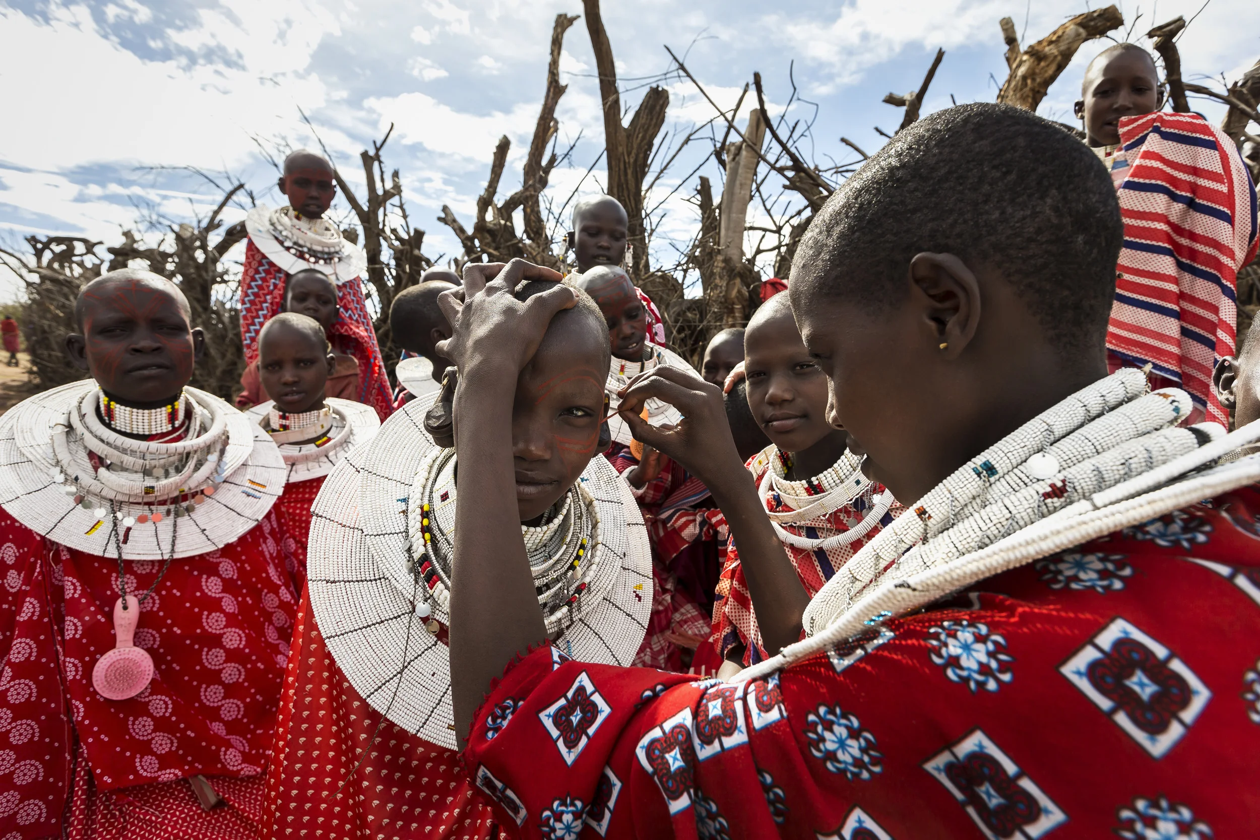 LOLIONDO, NORTHERN TANZANIA, NOVEMBER 2012: Images from a Masai coming –of-age ceremony in a remote Masai village in Loliondo, Northern Tanzania, 2 November 2012. Two of the young warriors in this ceremony are wearing a Lion Mane head-dress from a lion they speared 3 years ago. The Masai have a long history of lion-killing, both as a proving ground for young warriors in their ascent to manhood and also to protect their cattle from lion attacks. This is an illegal activity and 3 years ago a number of young warriors were arrested and jailed for this offence. Illegal lion killing continues amongst the Masai today, but as lion numbers dwindle, this activity is also increasingly rare to find. Conflict between the pastoralist Masai and the lion is an age-old phenomenon. (Photo by Brent Stirton/Reportage for National Geographic Magazine.)