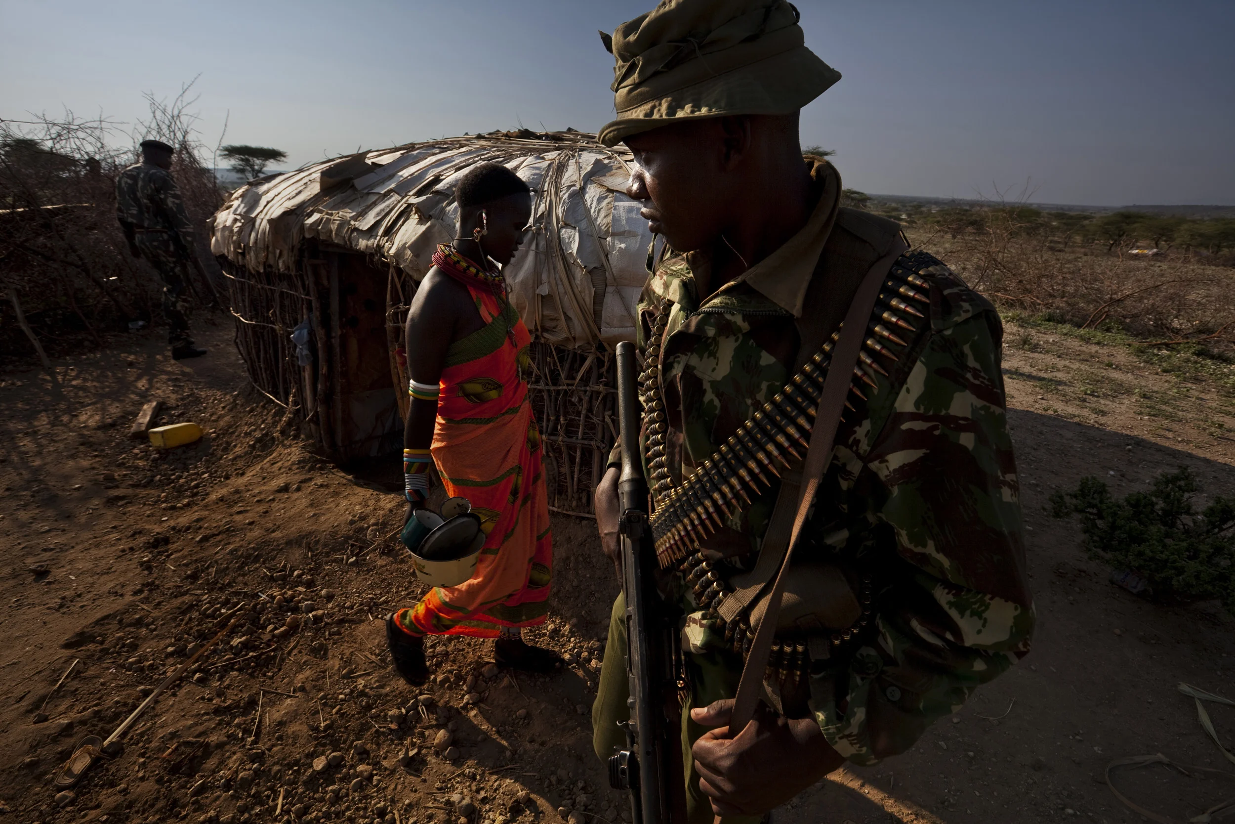 RIFT VALLEY PROVINCE, KENYA, NOVEMBER 2009: Controversial Kenyan Administrative Police search for weapons and suspects as they move through a Samburu village in the region of Samburu National Park in the north of Kenya at a time of the worst drought in Kenya for the last 100 years, 20 November 2009. 2 days after these pictures were taken, 12 people were killed in this area by the AP's, with claims of political motivations behind the killings. Most of the Samburu cattle have succumbed to the worst drought to hit Kenya in over 100 years and many Samburu now face starvation as a result of their decimated herds being unable to supply a steady food supply for communities. Tensions are high as pastoralists tribes as well as conservationists are all competing for tiny pockets of grazing land. Cattle raiding is commonplace and increasingly armed conflict over grazing rights is becoming the norm. (Photo by Brent Stirton/Reportage by Getty Images.)