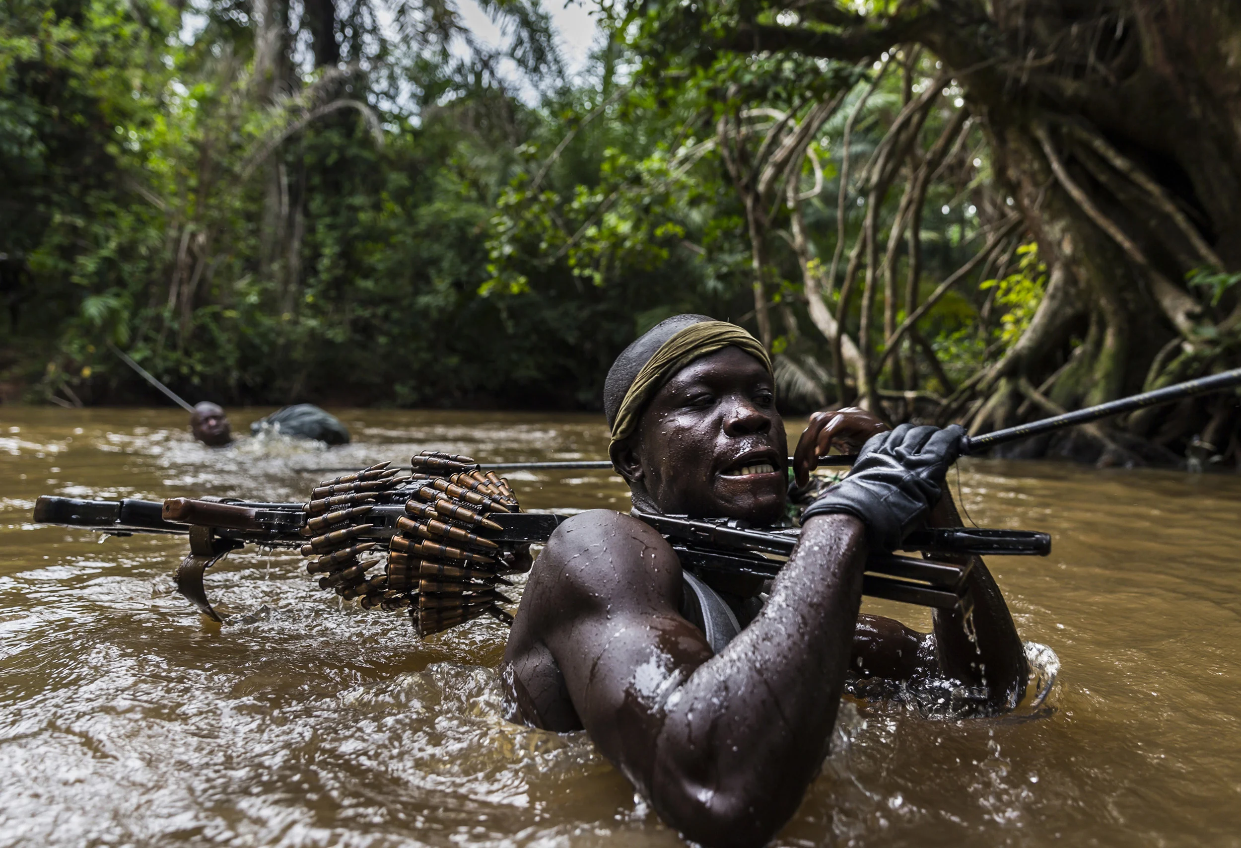 MBOKI, CENTRAL AFRICAN REPUBLIC, 25 NOVEMBER 2014: Soldiers on patrol from the African Union Ugandan Armed forces, UPDF, base at Mboki, Central African Republic. The Ugandan contingent based here are focused on the aprehension of the Lord's Resistance Army, LRA, the notorious rebel group led by Joseph Kony which has terrorized citizens of Uganda, C.A.R, South Sudan and the Democratic Republic of Congo for the last 4 decades. Soldiers are seen crossing a river, a technique they have perfected with ropes despite the fact that many of the men cannot swim. Captain (Photo by Brent Stirton/Reportage by Getty Images for National Geographic Magazine.)