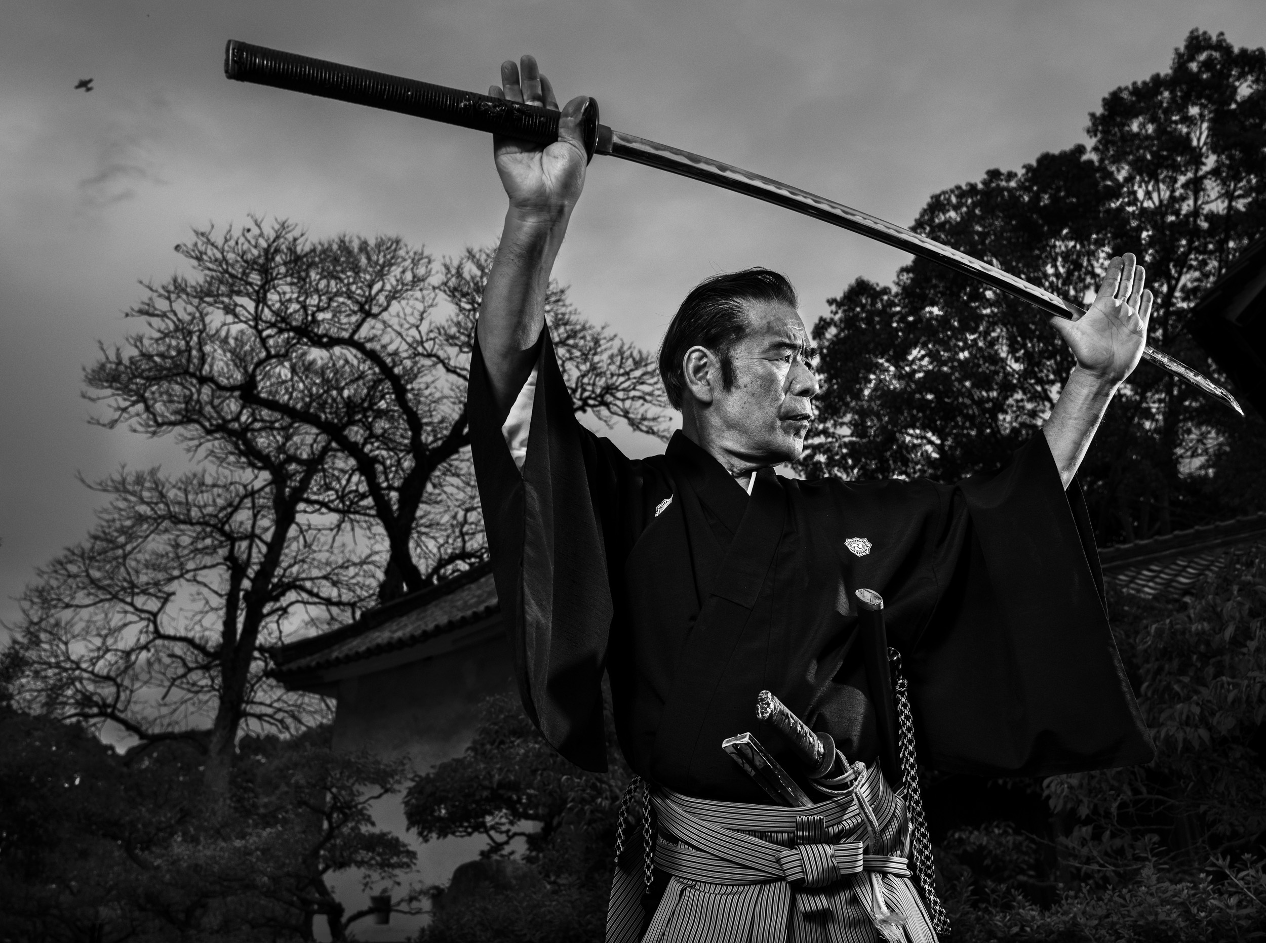 OSAKA, JAPAN, 19 OCTOBER 2014: Sensei Fumon Tanaka, 73, Samurai master and descendent of a long line of Samurai warriors in Japan. He is seen at a temple complex in Osaka, Japan. Sensei Tanaka is somewhat controversial amongst the pursuants of the S
