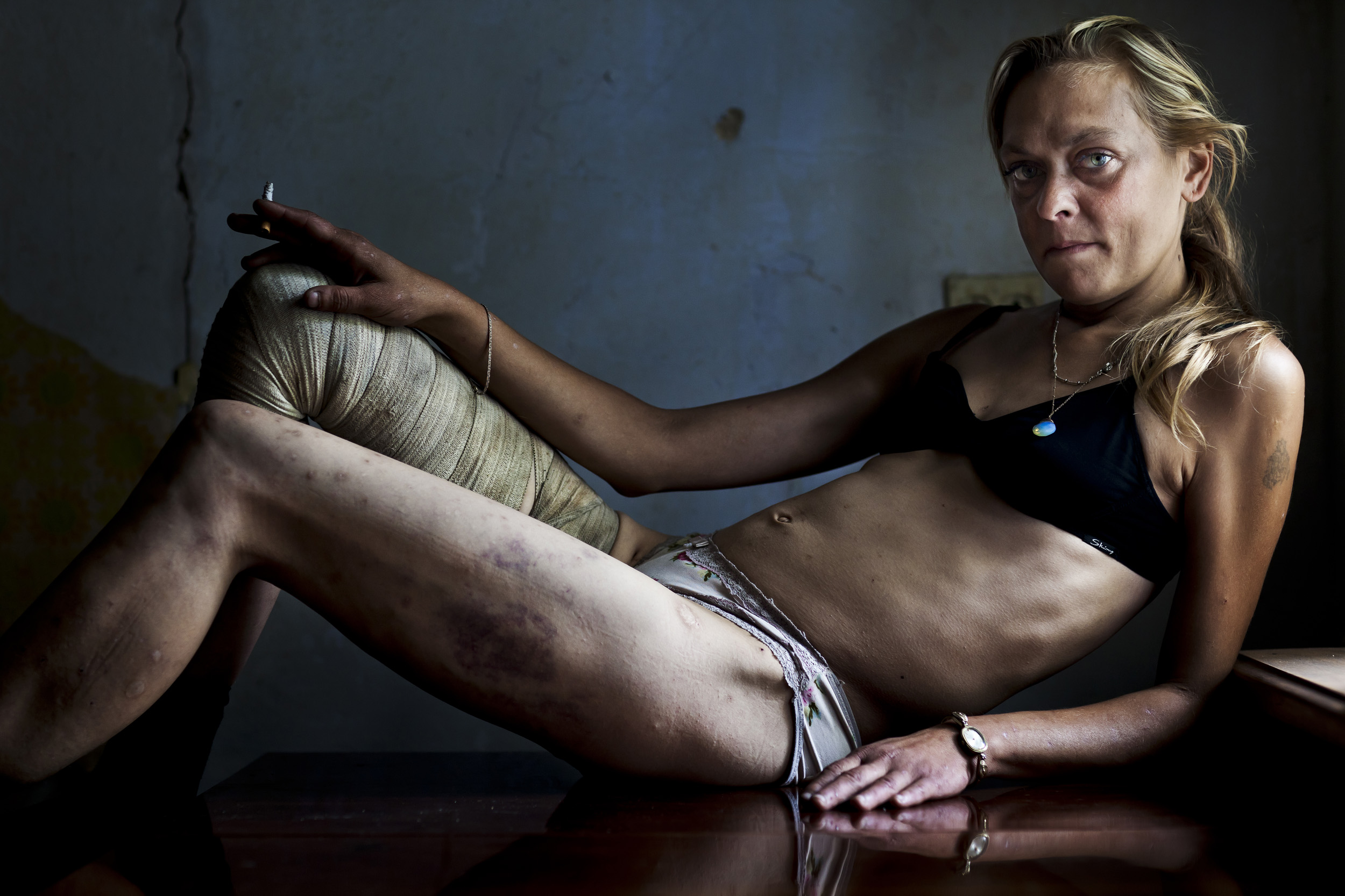 KRYVYI RIG, UKRAINE, AUGUST 2011: Maria, a drug addict and sex worker, entertains a client in a room she rents in a house from an old lady, Kryvyi Rig, Ukraine, 28 August 2011. Maria uses drugs on a daily basis and sees many men every week but remai