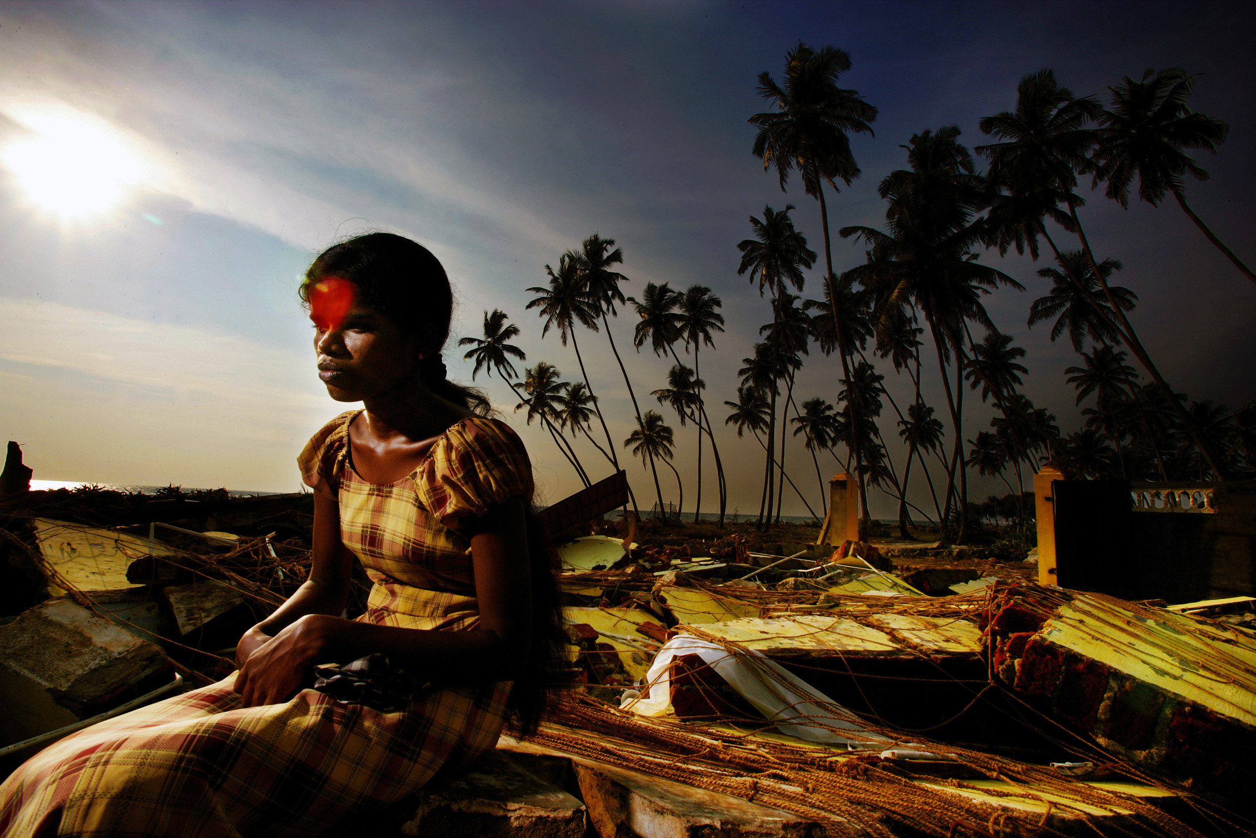 SOUTHERN SRI LANKA-NOVEMBER 2005: A Tsunami survivor sits and cries in the ruins of the house she used to share with her husband and two children. They were lost in the wave and she now lives in the ruins of the house trying to work out how to recla