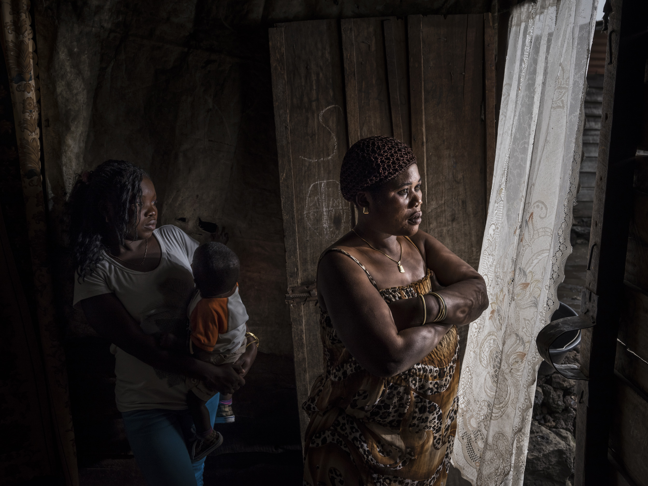 GOMA, DEMOCRATIC REPUBLIC OF CONGO, 22 JANUARY 2015: Benadete Kahindo, 32, seen with her eldest daughter Gift and 3 of her seven children. Benadete's husband was ICCN ranger Hassan Sebuyori, 34. In 2012 Hassan was targeted, killed and beheaded by FD