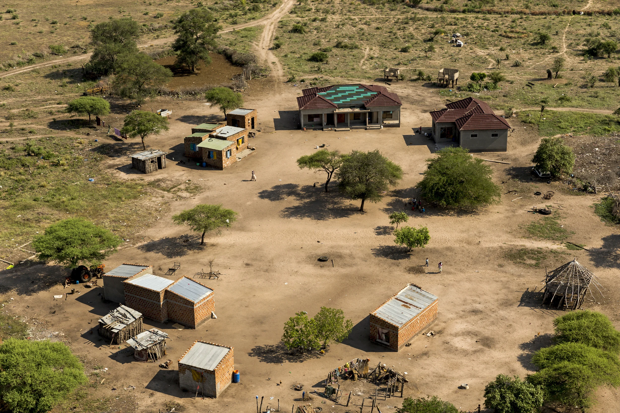 MOAMBA, MOZAMBIQUE, 19 APRIL 2016: An aerial view of the new home of a suspected high level weapons provider for illegal Rhino poaching in the Baptine area of Mozambique. Police were led to this home the night before by a rhino poacher who was arrested the day before with a silenced hunting rifle and bullets. This informant claims that the owner of this compound of houses is a significant weapons and transport co-ordinator for rhino poaching, the number one enrichment path in this impoverished area of Mozambique which border Kruger National Park. Two rhino poachers, one 19, the other 28 years old, apprehended by an anti-poaching team in Mozambique close to Kruger National Park border. After a three day chase they were caught in a roadblock and the rifle seized shortly thereafter. This was due to a co-ordinated effort between Kruger National Park in South Africa where the poachers intended to shoot rhino for their horn; and Sabi Game Park, a conservancy on the Mozabique side. The poachers were tracked and identified by their unique shoe pattern. They tried to say they had been on their way to buy cattle but had no money on their persons and the alleged cattle owner said he did not know anything about selling his cattle. A Czech CZ .458 hunting rifle was seized, complete with a professionally built silencer. Both men admitted their guilt and will be charged under new Mozambican law which states that possesion on the weapon and bullets indicates intent to poach rhino, this carries a maximum sentence of 12 years and/or $80,000.00. Their Toyota Hilux vehicle was also confiscated. The younger of the two poachers, 19, later led police to the homes of suspected weapons and transport suppliers, higher ups in the rhino poaching syndicates known as level 2's and 3's. Those men had fled by the time the police arrived but significant information was discovered in the form of identity documents, both real and forged, as well as banking account information. (Photo by Brent Stirton