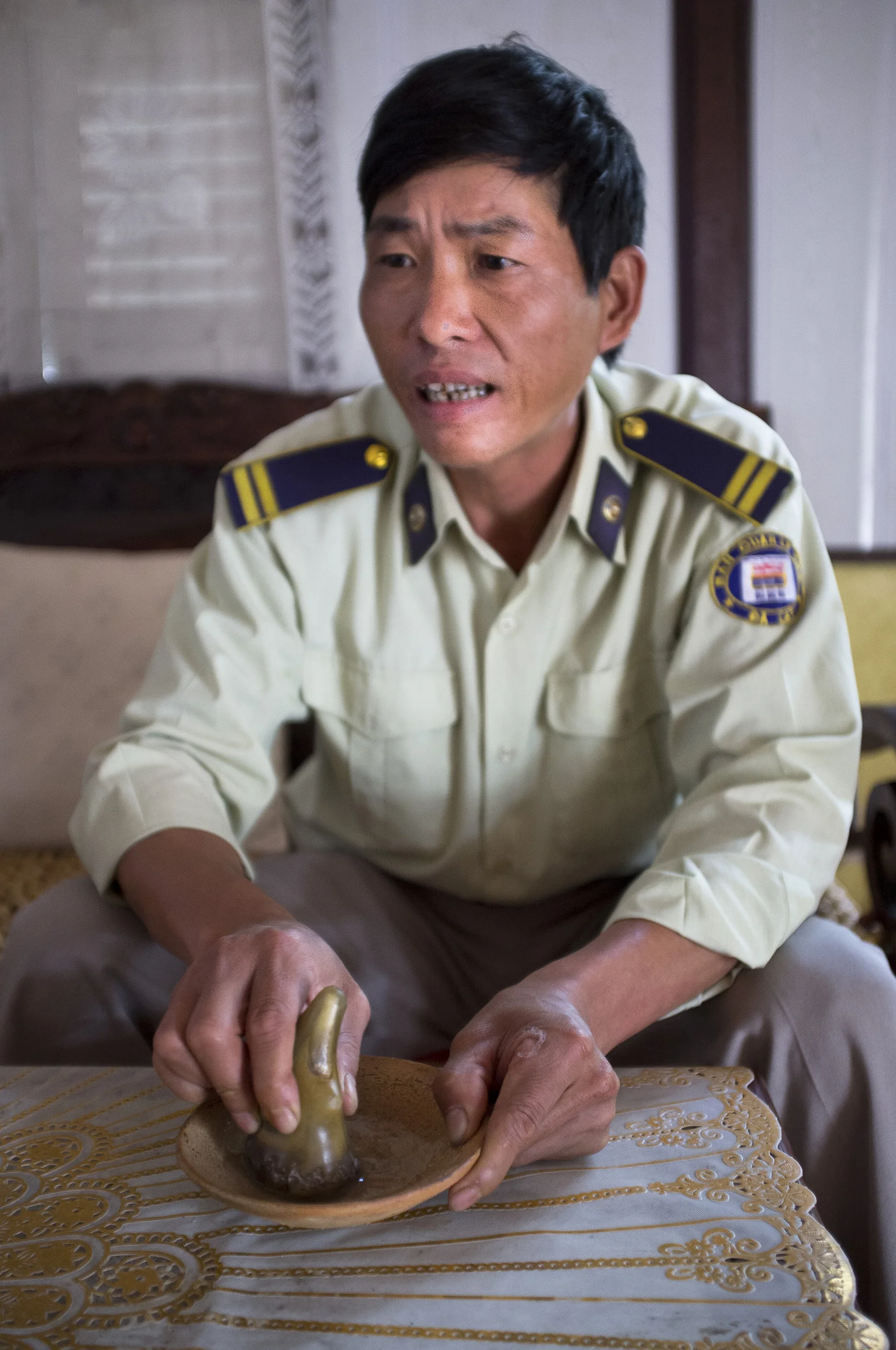 SAIGON, VIETNAM, OCTOBER 2011: A Vietnamese official grinds rhino horn in a backroom out of sight, Saigon, Vietnam, October 4, 2011. He had hoped to sell this horn which he says belongs to his family. Rhino horn is illegal in Vietnam yet sells for around $2500 per 100 grams for locals and for as much as $8500 per 100 grams for foreigners. (Photo by Brent Stirton/Reportage by Getty Images.)