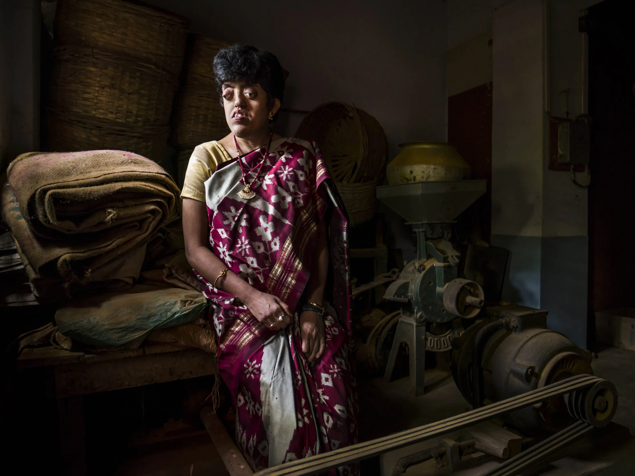VIVEKANANDA MISSION ASRAM, WEST BENGAL, INDIA, 14 JANUARY 2016: Jhulan Mukherjee, 39, is a former pupil from the Vivekananda Mission Asram School for the blind, she is a successful teacher at a school for sighted pupils today. Jhulan learnt braille at home from a young age but says she would not have had any success without her time at Vivekananda. Jhulan had a very difficult time with prejudice against the blind, despite being a very talented student. After school she studied English Literature for 3 years attaining her Bachelors degree, she then did a masters in English as well as another BA in education. She decided to become a teacher but was refused access to the entrance examinations. She became part of a movement for the rights of the Blind in India and took her case to court. The court ruled that she had the right to become a teacher and Jhulan passed her examinations on her first try. The first school she was assigned to was prejudiced against her and refused to let her teach. Another legal fight ensued and the District Inspector of Schools intervened on Jhulan's behalf and actually declassified the school for their prejudicial audacity. Jhulan then had to deal with the School Service Commision regarding her blindness but passed her exam and was finally allowed to teach at her second school posting. Jhulan has taught successfully as a blind person at Talbagicha High School in Kharagpur, West Bengal for more than ten years now. She is seen with her son who has the same hereditary issues as herself. (Photo by Brent Stirton/Reportage for National Geographic Magazine.)