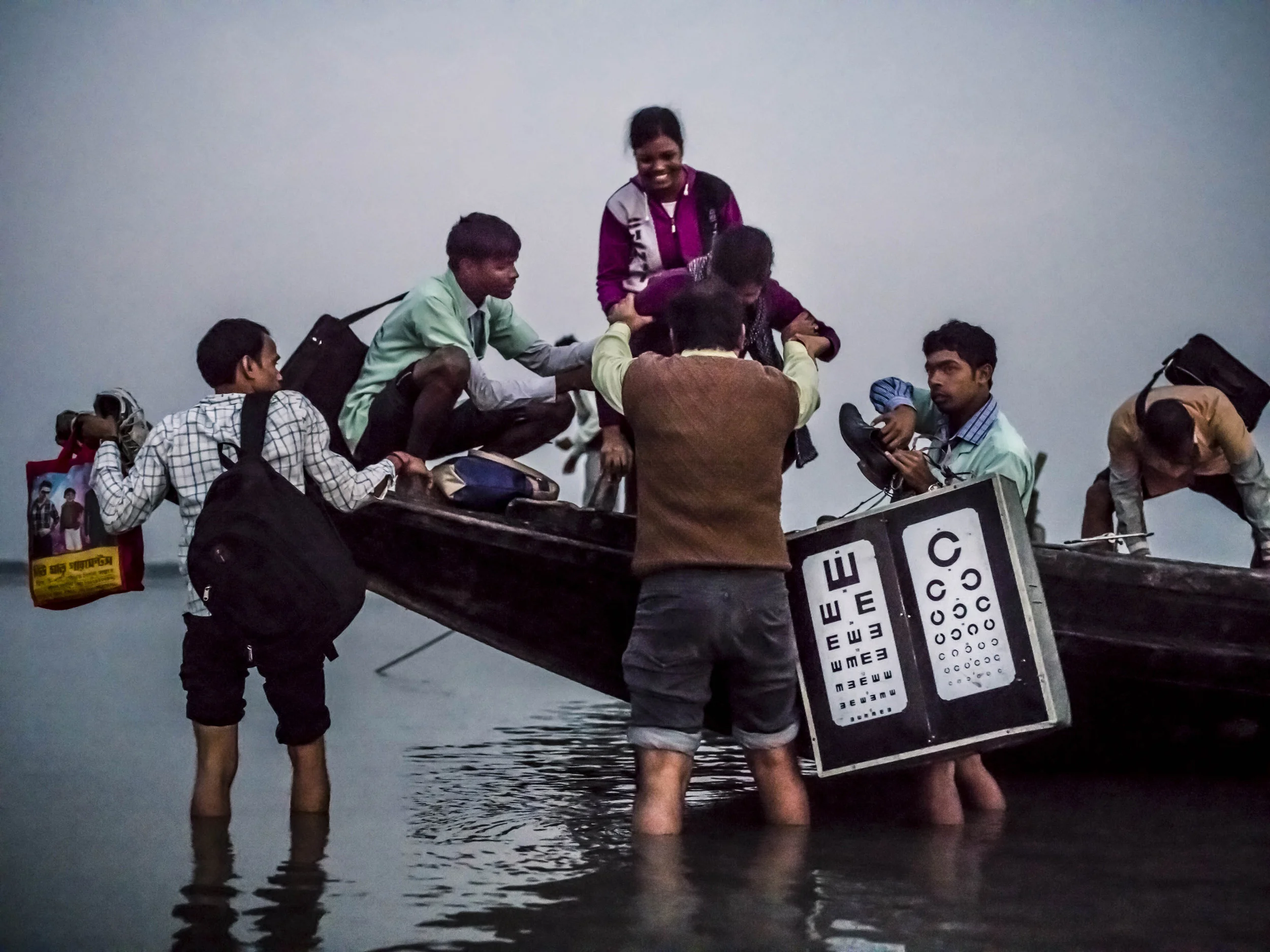 Sundarbans, India, 11 January 2016: Dr Asim Sil leads a team of eye care specialists on a boat-camp for eye care in a remote part of the Sundarbans, India. These boats are often used in partnership with other NGO’s, offering general healthcare facilities as well as eye health diagnosis to extremely impoverished villages deep within the Sundarbans. Dr Sil’s team uses boats to get around the Sundarbans and often works from early morning to late at night on patients who would otherwise not have access to good eye care. The goal of the team is to educate and offer refractive services, ie glasses; to diagnose eye health problems and to offer surgical solutions to patients who need them, including transport to the hospitals. These services are provided free of charge by Vivekananda Mission Asram hospital. Dr Sil has worked on eye care in the Sundarbans since 1989, and along with his team has been of service to thousands of patients in this remote region of India. A high povery index and remoteness of location coupled with a lack of access to quality eye care has seen India become the country with the highest number of blind people. Most of these cases began as problems that if diagnosed earlier, could have been prevented. (Photo by Brent Stirton/Reportage for National Geographic Magazine.)