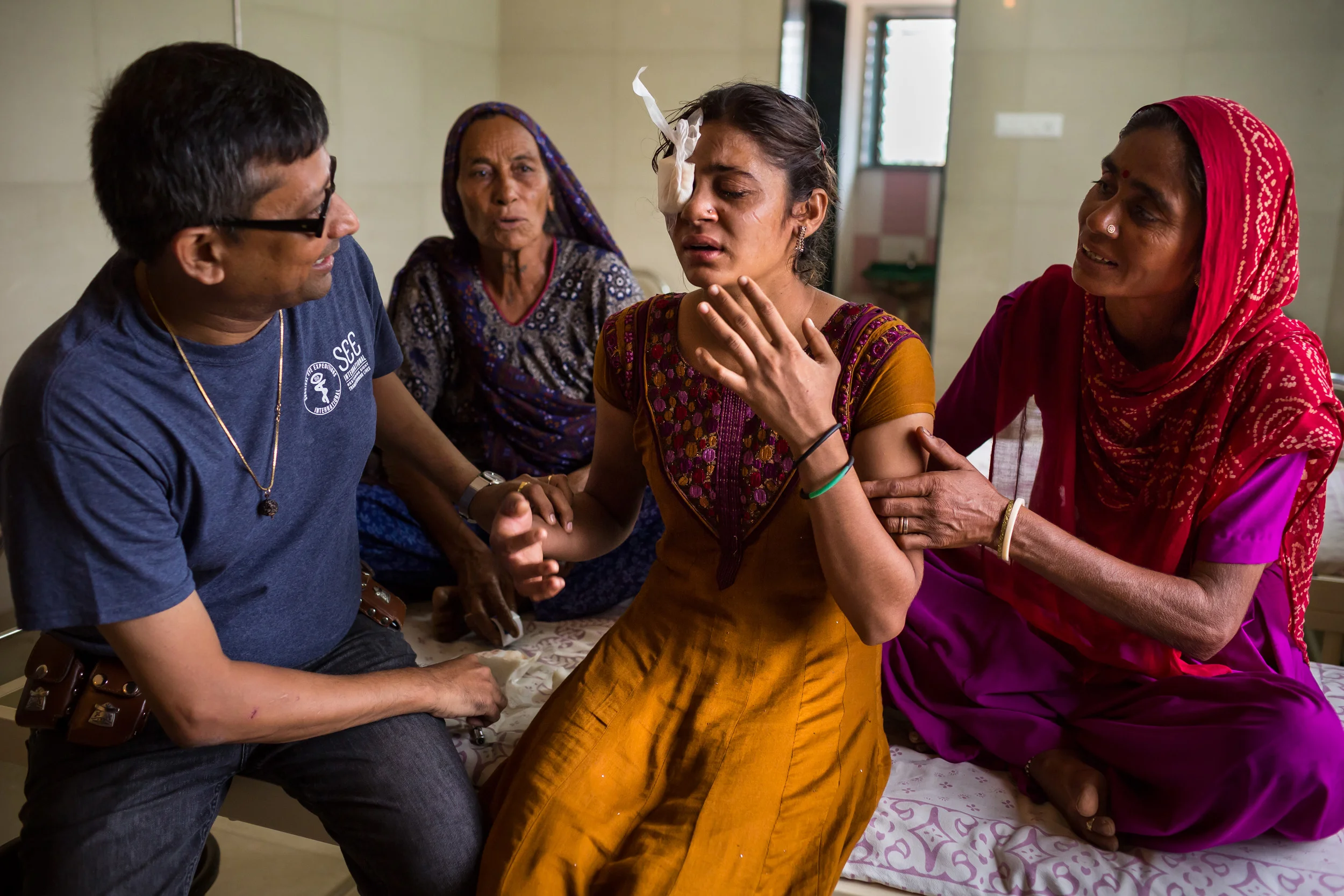 SHRI BHOJAY SARVODAYA EYE HOSPITAL, BHUJ, KUTCH, INDIA, JULY 22 2015: Dr Janak Shah examines patients after a series of successful eye surgreries. He is an accomplished and prolific eye surgeon who volunteers his services to the global poor via SEE International, an NGO with a focus on curing blindness. He is seen examining patients after he haHe and his wife Preeti are seen examining and performing eye surgery at the Shri Bhojay Sarvodaya Eye hospital close to the India Pakistan border. This is a new hospital that offers modern facilities to SEE where Janak can run a blindness camp as well as perform the surgeries required. Janak graduated from the University of Bombay in 1991, and completed his residency in ophthalmology in 1996. He’s been volunteering with SEE International as an eye surgeon since 1996, and in 2013, passed the milestone of 100 SEE expeditions. He is SEE’s most prolific doctor and has worked in places like the Peruvian Jungle, Gaza Strip, Lebanon, Mongolia, China, Brazil and many other remote locations. He has worked all over India and has performed thousands of eye surgeries, addressing every kind of illness. Janak is a proud adherent of the Jainism religion; he is a strong believer in their religious tenants of mankind being one. Janak often works with his wife Preeti, herself a talented eye surgeon. Together they are a formidable force and can work quickly on a multitude of surgeries in a single day. They have two daughters, one of 11 and the other 15. Both girls often travel with their parents on their volunteer trips for SEE and actively assistant in patient diagnosis as well as assisting their parents in surgery. Janak and Preeti both believe this gives the girls a real perspective on their place in the world and helps to bind them as a family unit. The Shahs live in Mumbai, India and run a successful eye surgery practice when they are not volunteering for SEE International. (Photo by Brent Stirton/Novartis)