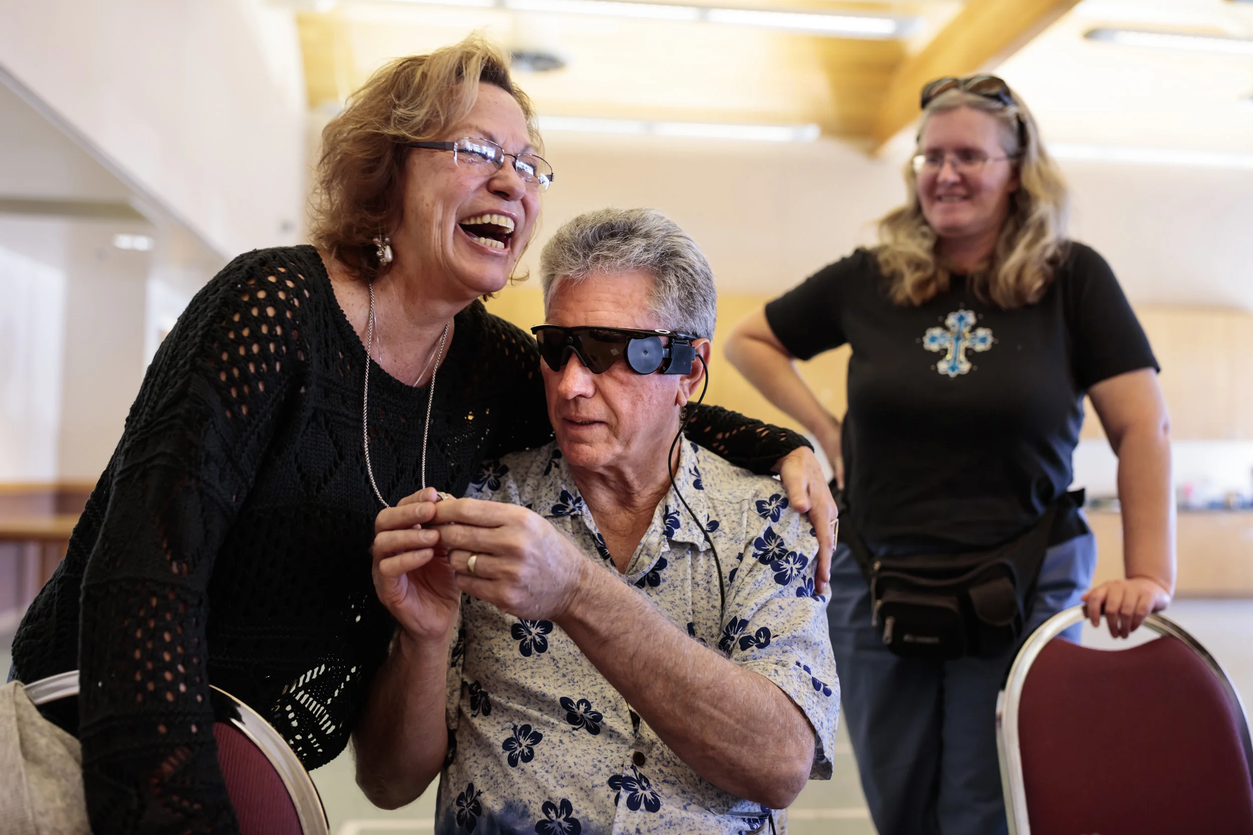 RIVERSIDE, LOS ANGELES, CALIFORNIA, USA, 16 FEBRUARY 2016: Terry Byland, 67, is the only person in the world who has had both the Argus Retinal Prosthesis systems installed in both of his eyes. Terry lost his sight to Retinitis Pigmentosa, a disease that attacks the photoreceptor cells in the retina. This left Terry blind by age 45. 11 years later he underwent the first operation, implanting the first version of the Argus device inside his eye. From 2004 to 2010 Terry was part of the study for the development of that device. He says that he was interested in being a pioneer for a study that could one-day benefit thousands of the blind. In June 2015 Terry received the second generation Argus 2 prosthetic in his left eye. Since then he has not activated the first generation device. He continues to work with Second Sight, the developers of the device, to bring this technology forward. Terry credits the Argus technology with giving him a greater sense of independence and thus a greater sense of self-worth. He is seen visiting with the Braile Club, a support group for blind people he has attended for over 10 years in his home town of Riverside, LA. He is seen making announcements, singing in the choir, playing Bingo and generally interacting with volunteers and other blind people. Terry is able to make out shapes and forms that appear to him in a form of lights and darks, this is a new visual language that he and other Argus users develop. Terry ends his day with his son Daniel as they go for fast food close to his home. “The Argus II helps patients recognize large letters, locate the position of objects and more. It restores some visual capabilities for patients whose blindness is caused by Retinitis pigmentosa (RP), an inherited retinal degenerative disease that affects about 100,000 people nationwide. The system includes a small video camera mounted on a pair of eyeglasses, a video processing unit that transforms images from the camera into wirelessly-transmitt