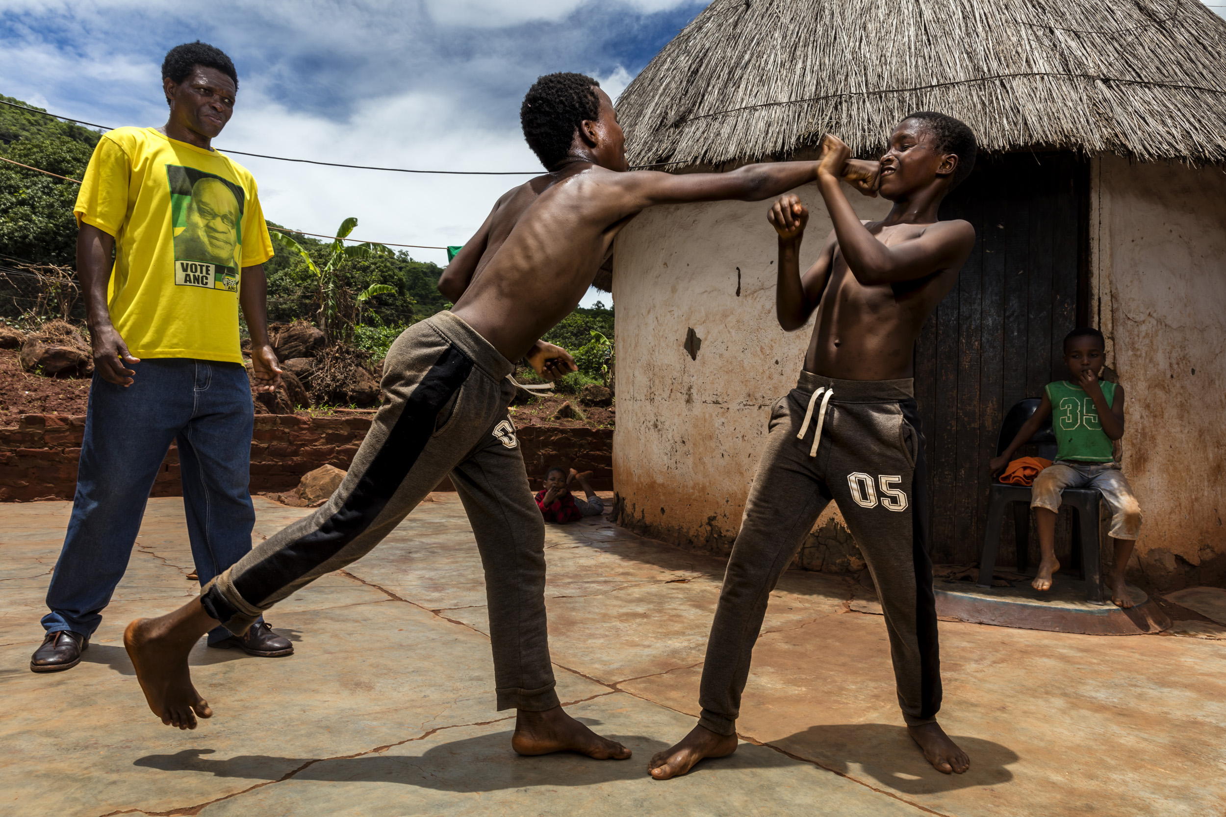 VENDA, SOUTH AFRICA, 11 DECEMBER 2016: "Poison" Ndevana, 58, is the president of the Musangwe Comittee in Venda, he is seen training his two eldest boys Mudshidzi, 15, and Nanjana, 13. Poison says his two eldest are still too young to train seriousl