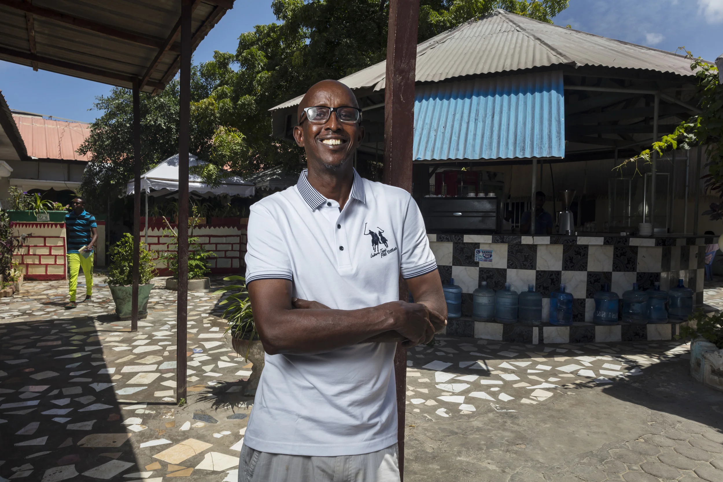 MOGADISHU, SOMALIA, 5 AUGUST 2017: Ahmed Jama, the owner of Village restuarants in Mogadishu, is seen at one of his restuarants. Jama has been attacked by suicide bombers more than 6 times since he moved back to Somalia from the UK in 2008. In the UK, he ran a successful catering business but now employs over 100 Somalis at his 4 restuarants. He remains optimistic, despite the added tragedy of losing his wife to a traffic accident in the last year. "I wanted to be a visionary for Somalia, to show people that it is possible to build something here. Mogadishu is definitely improving, Rome just wasn't built in one day. I am an asset for the Somalia nation and therefore I must be here. Small business development is key to Somalia's development, employment is equally important in the peacemaking process that must happen here. When yong people see that it is possible, it will not be so easy to recruit them for war." (Photo by Brent Stirton/Verbatim for Time Magazine.)