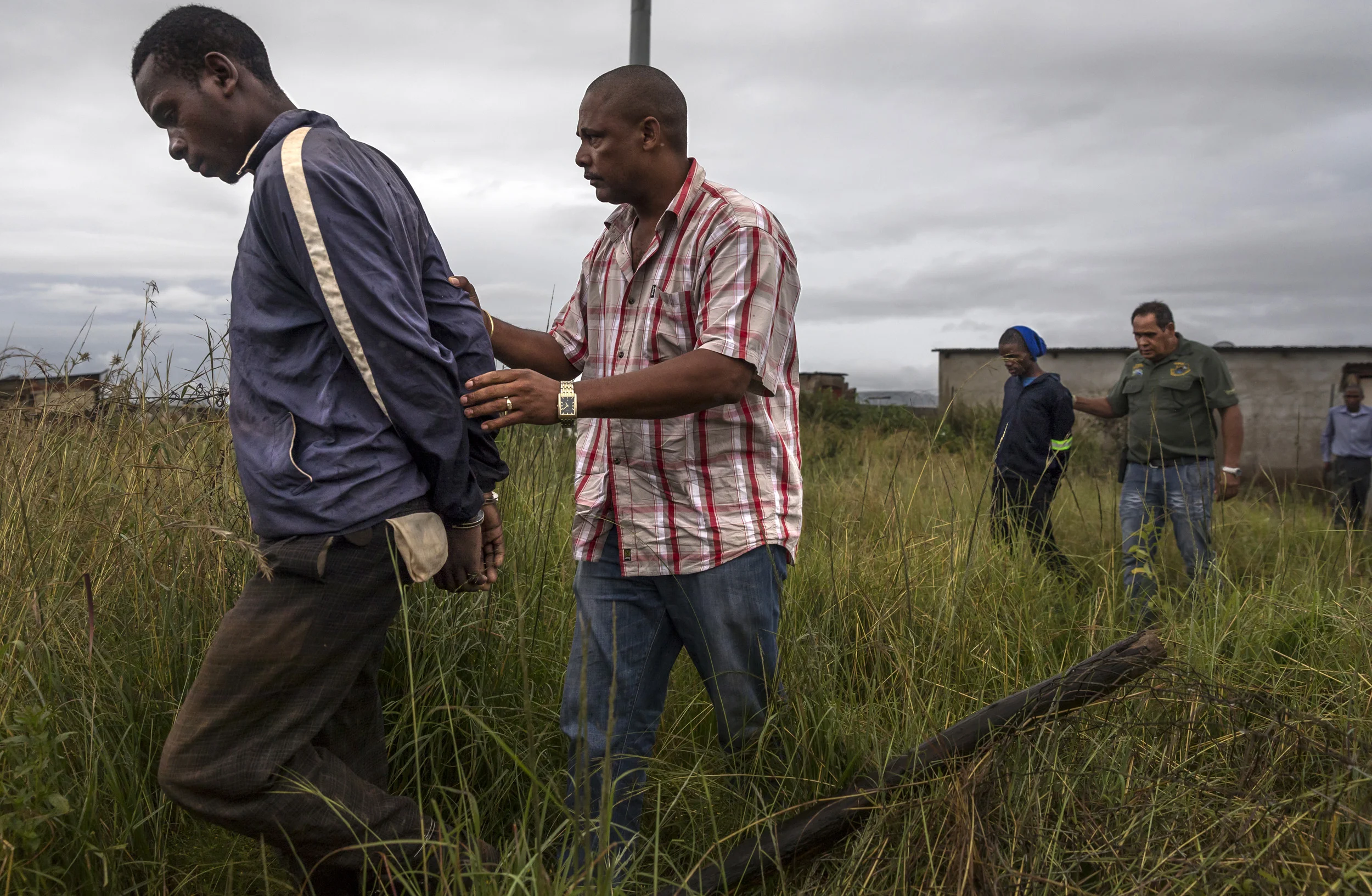 LYDENBERG, SOUTH AFRICA, 22 FEBRUARY 2017: South African Police and members of Heritage Protection Group, an NGO specializing in serious crime investigation, arrest farm attackers in Lydenberg, South Africa. These attackers invaded the farm home of an elderly man living alone. They beat him badly, tied him to a chair and tortured him all the while demanding money. These suspects were caught through the sister of one of the men using stolen property from the attack. They confessed and the victim’s wallet, bankcards, rifle and building tools were recovered in the course of the arrest. These men will now face up to 20 years for the attack if convicted. Heritage Protection Group is made of ex-policemen with very good investigative records. They were founded to help to make up for a lack of investigative experience in the post-apartheid South African Police force. There is currently at least one farm attack a day in South Africa; violence is common as is murder. (Photo by Brent Stirton/Verbatim for Getty Images.)