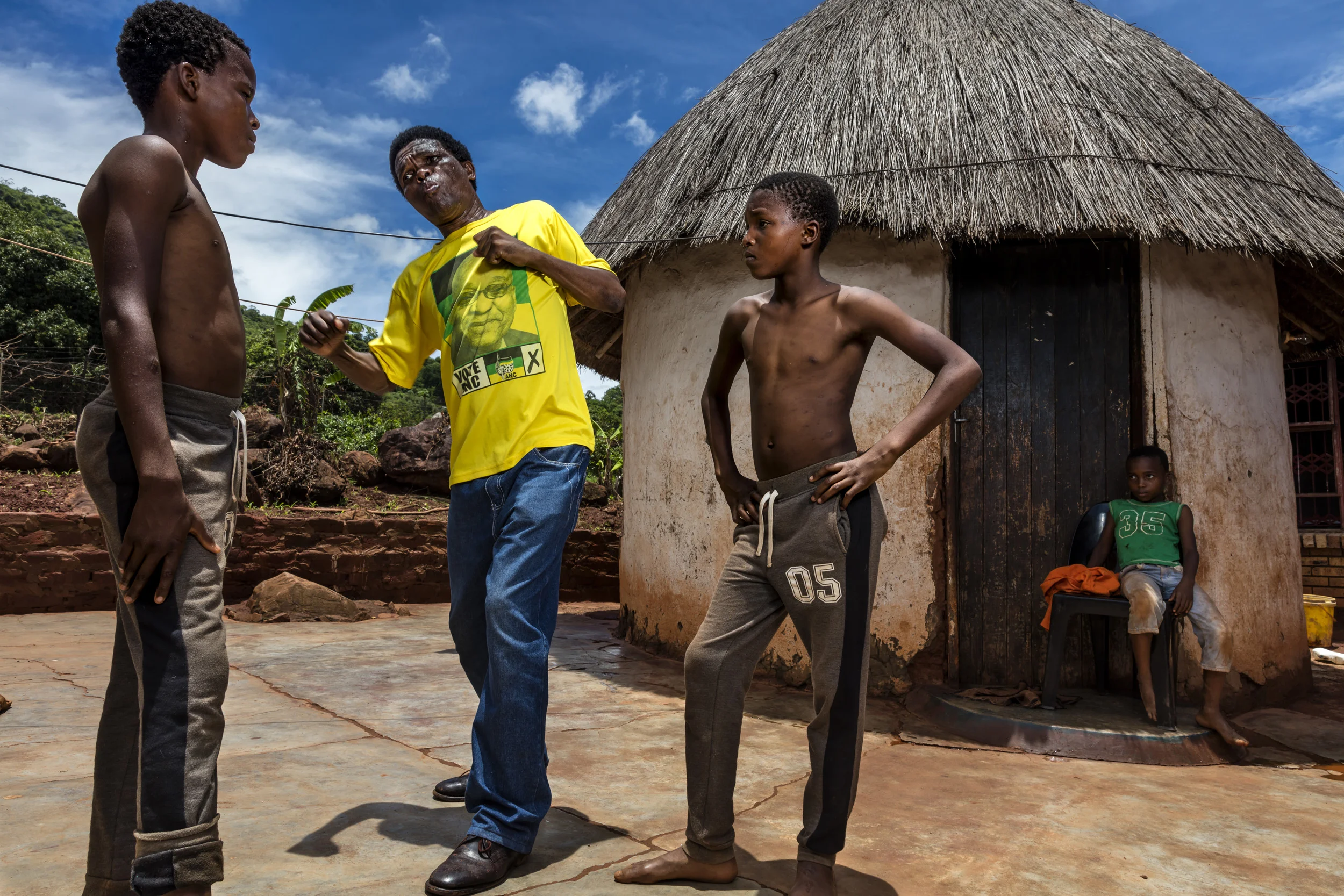 VENDA, SOUTH AFRICA, 11 DECEMBER 2016: "Poison" Ndevana, 58, is the president of the Musangwe Comittee in Venda, he is seen training his two eldest boys Mudshidzi, 15, and Nanjana, 13. Poison says his two eldest are still too young to train seriously but he sees them as future champions. The two boys fight at every Musangwe event and are fearless of their opponents. Musangwe is traditional bare knuckle boxing which occurs in Venda every Xmas period. Poison is a former Umkhonto Wi Sizwe ANC military wing fighter but he was already a Musangwe Champion before he joined the Liberation movement. (Photo by Brent Stirton/Verbatim for Le Figaro.)