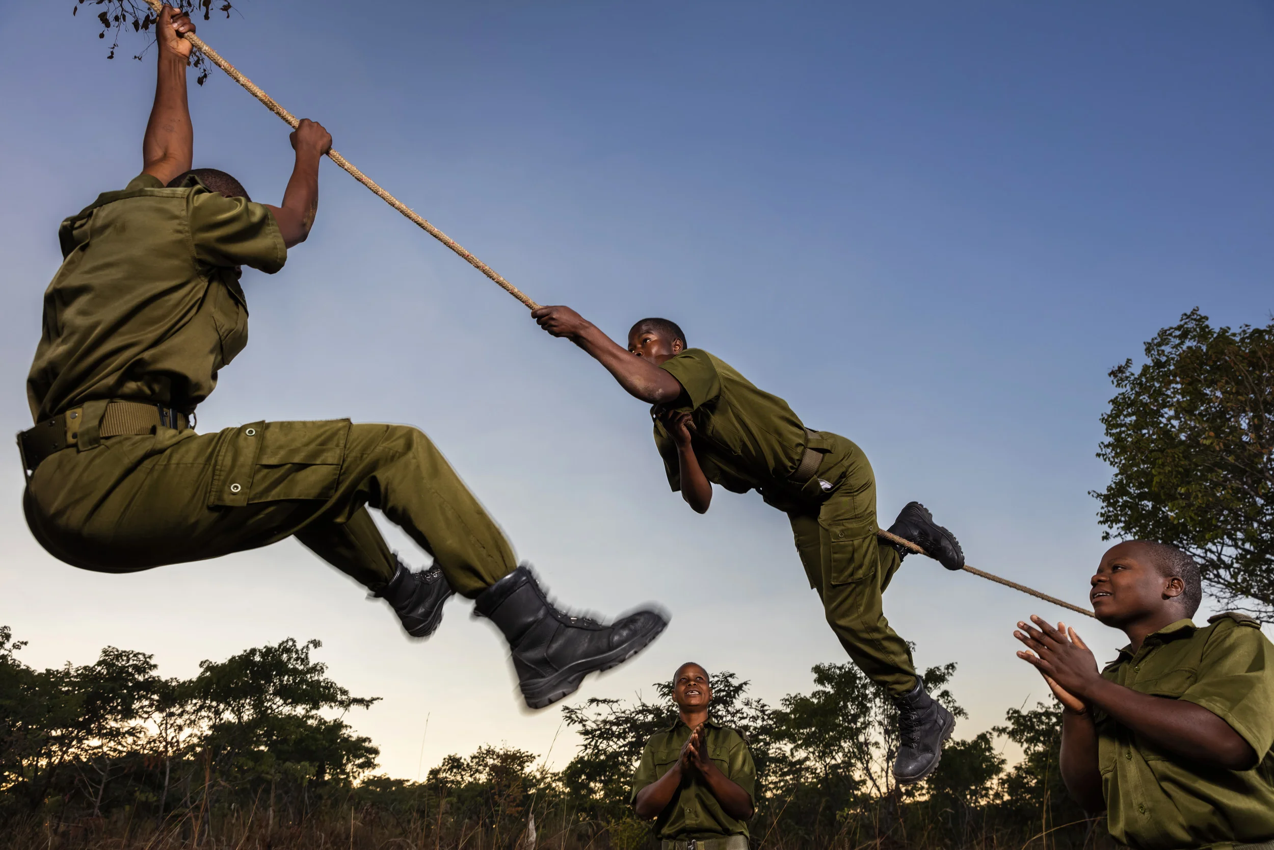 PHUNDUNDU WILDLIFE AREA, ZIMBABWE, JUNE 2018: Members of the all female conservation ranger force known as Akashinga undergo tough training in the bush near their base. Akashinga (meaning the ‘Brave Ones’ in local dialect) is a community-driven conservation model, empowering disadvantaged women to restore and manage a network of wilderness areas as an alternative to trophy hunting. Many current western-conceived solutions to conserve wilderness areas struggle to gain traction across the African continent. Predominately male forces are hampered by ongoing corruption, nepotism, drunkenness, aggressiveness towards local communities and a sense of entitlement. The I.A.P.F, the International Anti-Poaching Foundation led by former Australian Special Forces soldier Damien Mander, was created as a direct action conservation organisation to be used as a surgical instrument in targeting wildlife crime. In 2017 they decided to innovate, using an all- female team to manage an entire nature reserve in Zimbabwe. The program builds an alternative approach to the militarized paradigm of ‘fortress conservation’ which defends colonial boundaries between nature and humans. While still trained to deal with any situation they may face, the team has a community-driven interpersonal focus, working with rather than against the local population for the long-term benefits of their own communities and nature. Cut off from places of worship and burial, grazing areas, access to water, food, traditional medicine and given limited opportunity for employment or tourism benefits, it’s little wonder many of these communities struggle to see any value in conservation efforts.
Women have traditionally played major roles in battle and are now re-emerging as key solutions in law enforcement and conflict resolution. In the Middle-East, counterinsurgency operations that involve penetrating and working with the local population to try and win the hearts and minds have become fundamentally relian