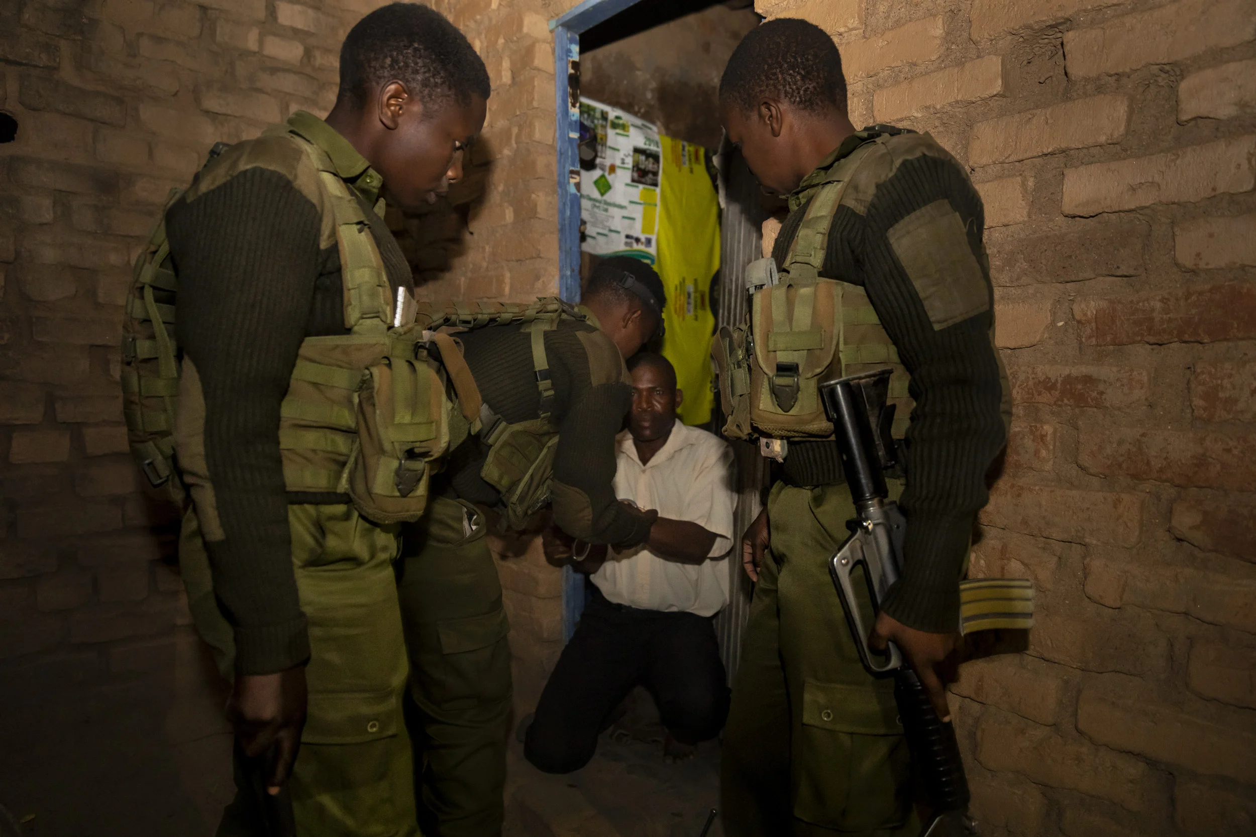 MAKUTI, ZIMBABWE, DECEMBER 2018: Members of the all- female conservation ranger force known as “Akashinga” arrest a notorious wildlife poacher and confiscate hunting rifles used to illegally shoot wildlife. Intelligence for the operation was gathered through the Akashinga community intelligence networks and M.A.P.P, an anti-poaching group that works hand in hand with these female rangers. Akashinga (meaning the ‘Brave Ones’ in local dialect) is a community-driven conservation model, empowering disadvantaged women to restore and manage a network of wilderness areas as an alternative to trophy hunting in Zimbabwe. Predominately male forces are hampered by ongoing corruption, nepotism, drunkenness, aggressiveness towards local communities and a sense of entitlement. The I.A.P.F, the International Anti-Poaching Foundation led by former Australian Special Forces soldier Damien Mander, was created as a direct action conservation organisation to be used as a surgical instrument in targeting wildlife crime. In 2017 they decided to innovate, using an all- female team to manage an entire nature reserve in Zimbabwe. The program builds an alternative approach to the militarized paradigm of ‘fortress conservation’ which defends colonial boundaries between nature and humans. While still trained to deal with any situation they may face, the team has a community-driven interpersonal focus, working with rather than against the local population for the long-term benefits of their own communities and nature.